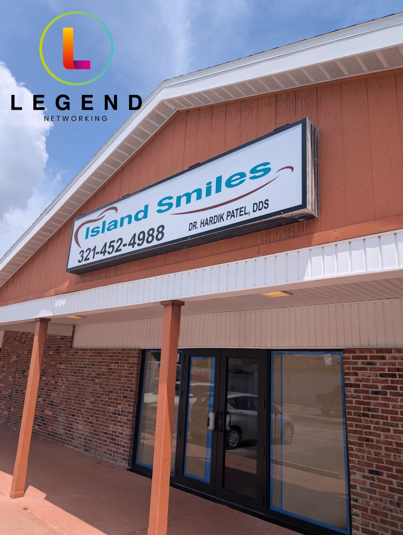 Island Smiles building sign with Dr. Hardik Patel's name above the entrance, Merritt Island, FL