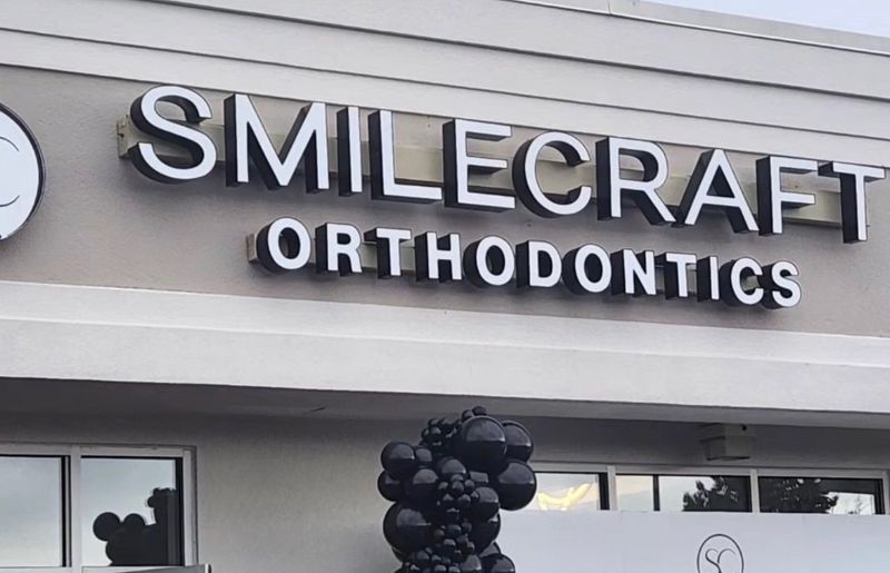 Smile Craft Orthodontics storefront sign in Jessup, Maryland, with opening-day balloons.