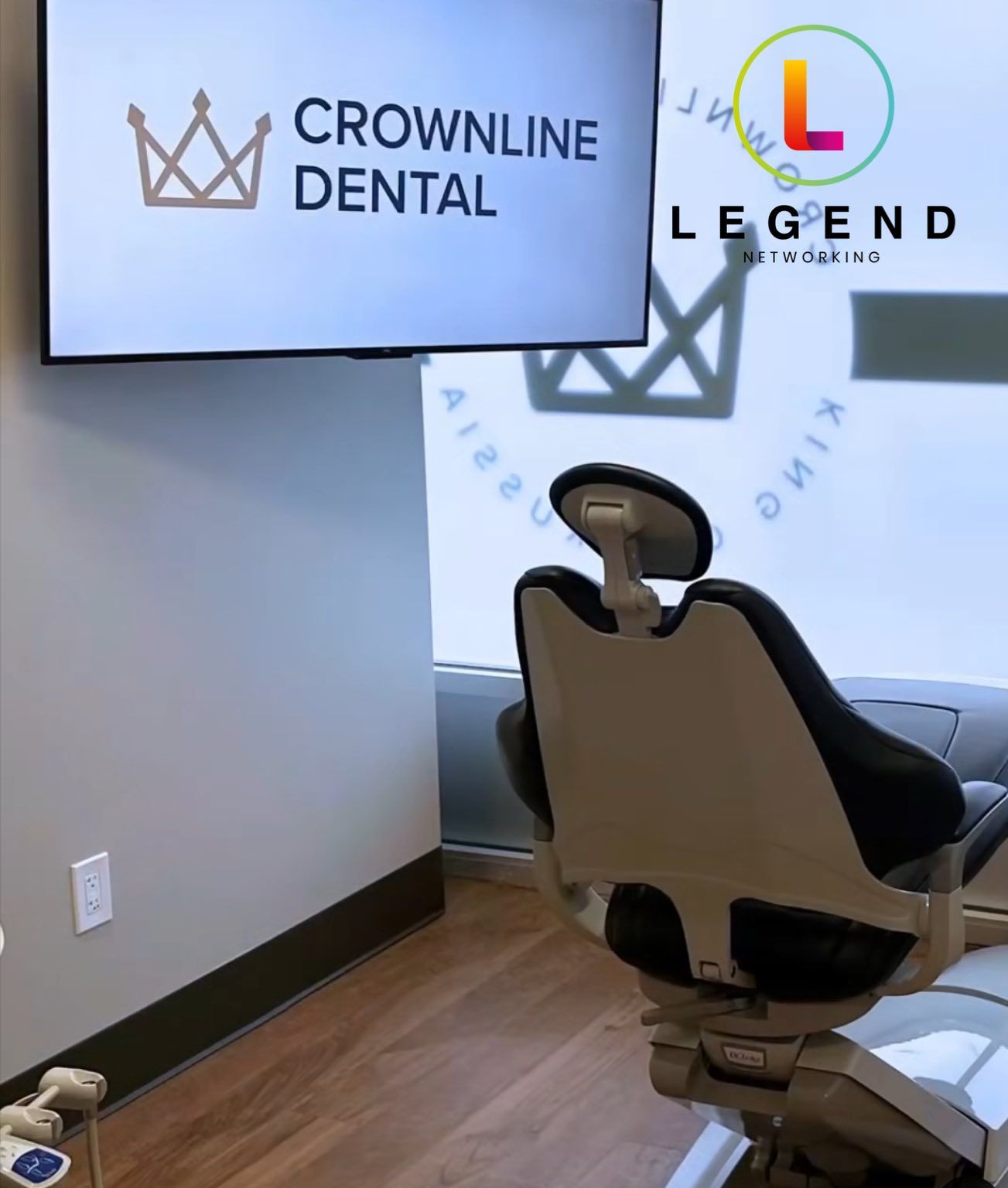 Treatment room with a wall-mounted TV and dental chair at Crownline Dental in King of Prussia