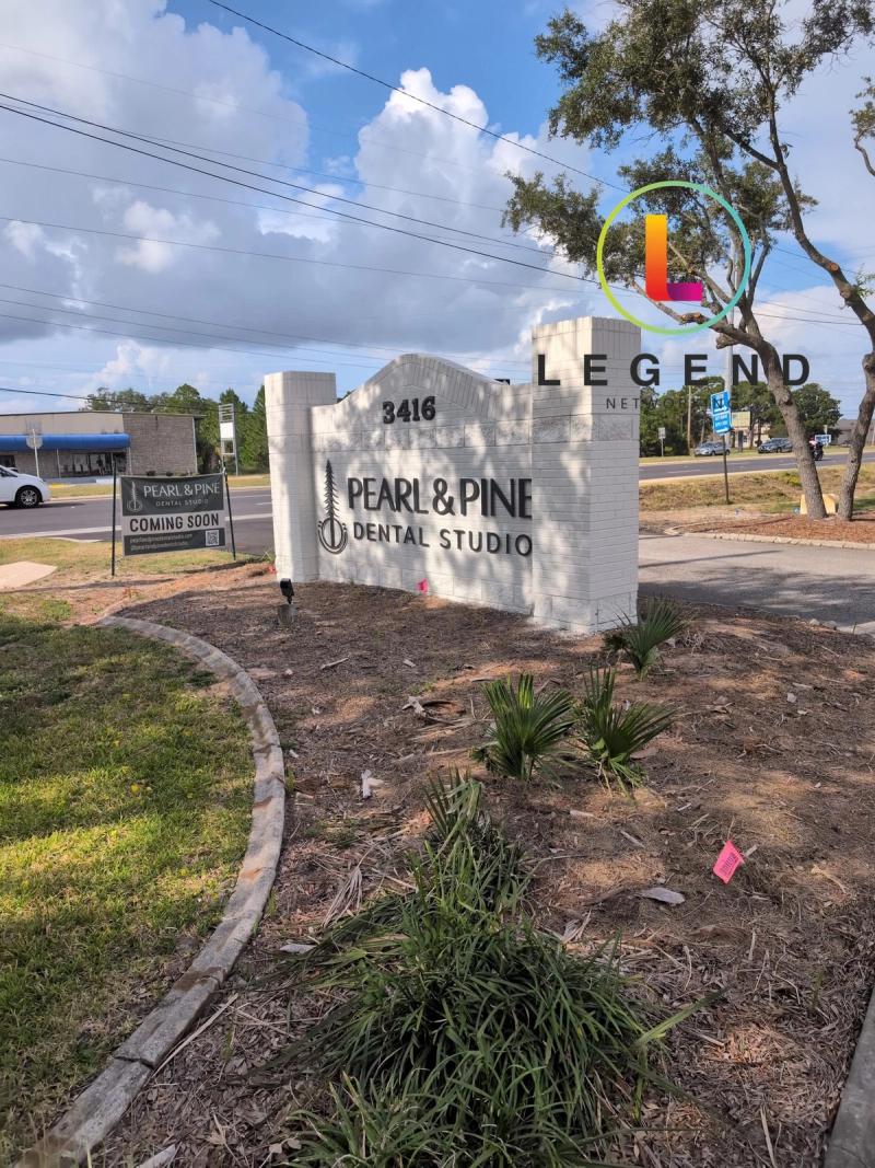 Monument sign and coming-soon banner for Pearl & Pine Dental Studio in Gulf Breeze