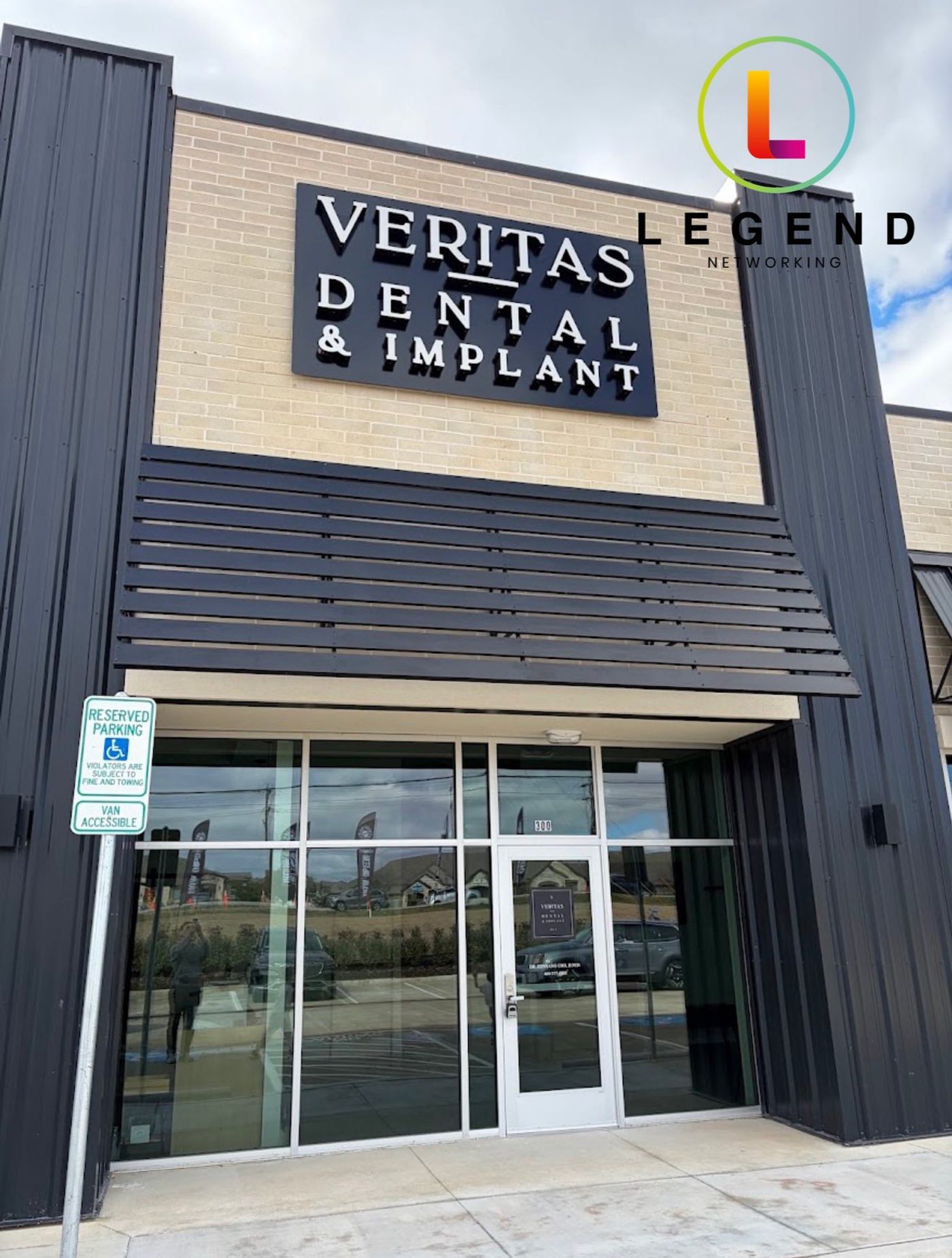 Storefront with Veritas Dental & Implant sign above the entrance in Aubrey, TX