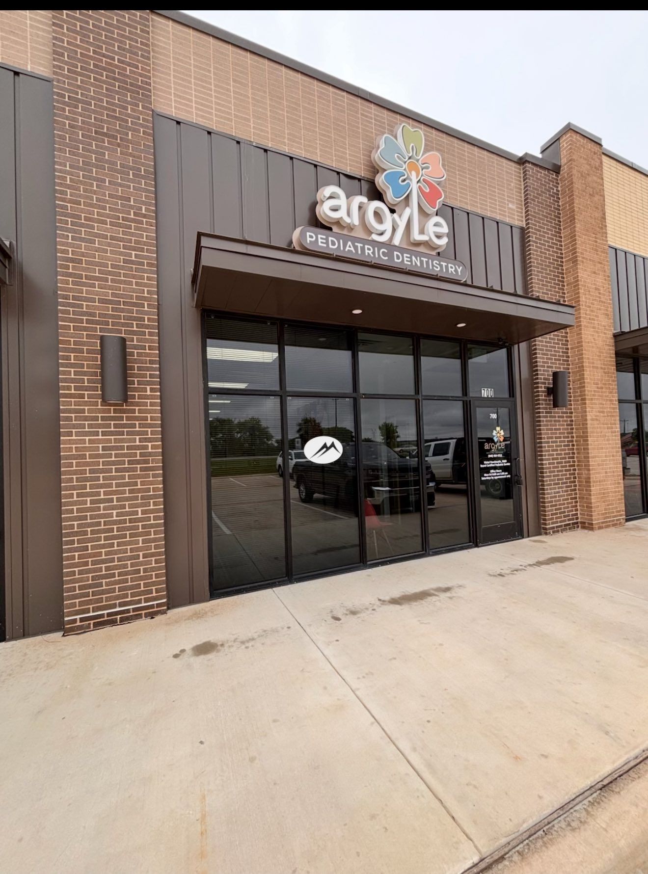 Storefront and illuminated sign at Argyle Pediatric Dental in Argyle