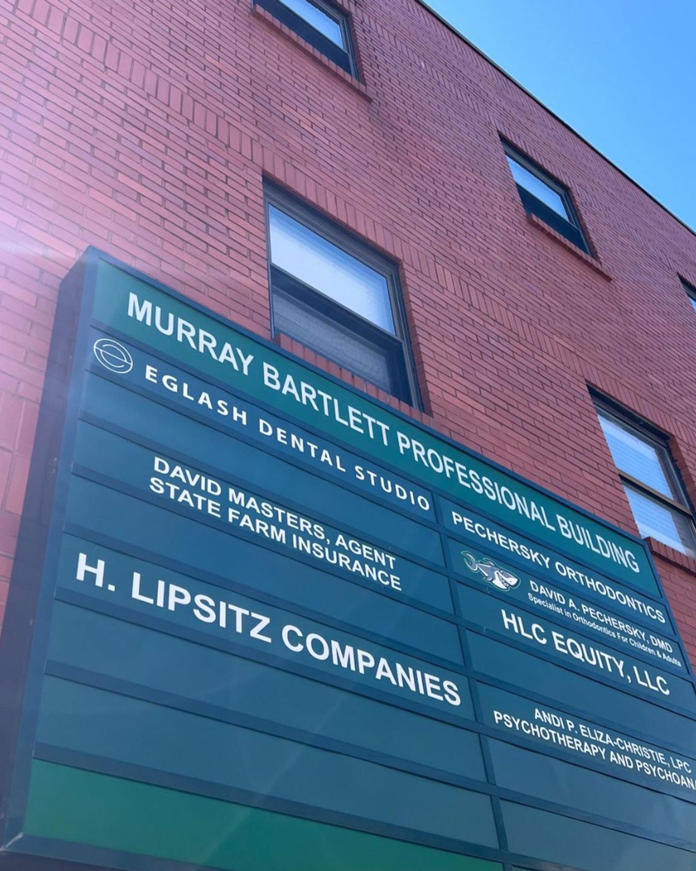 Building directory sign listing Eglash Dental Studio among its tenants in Pittsburgh, PA