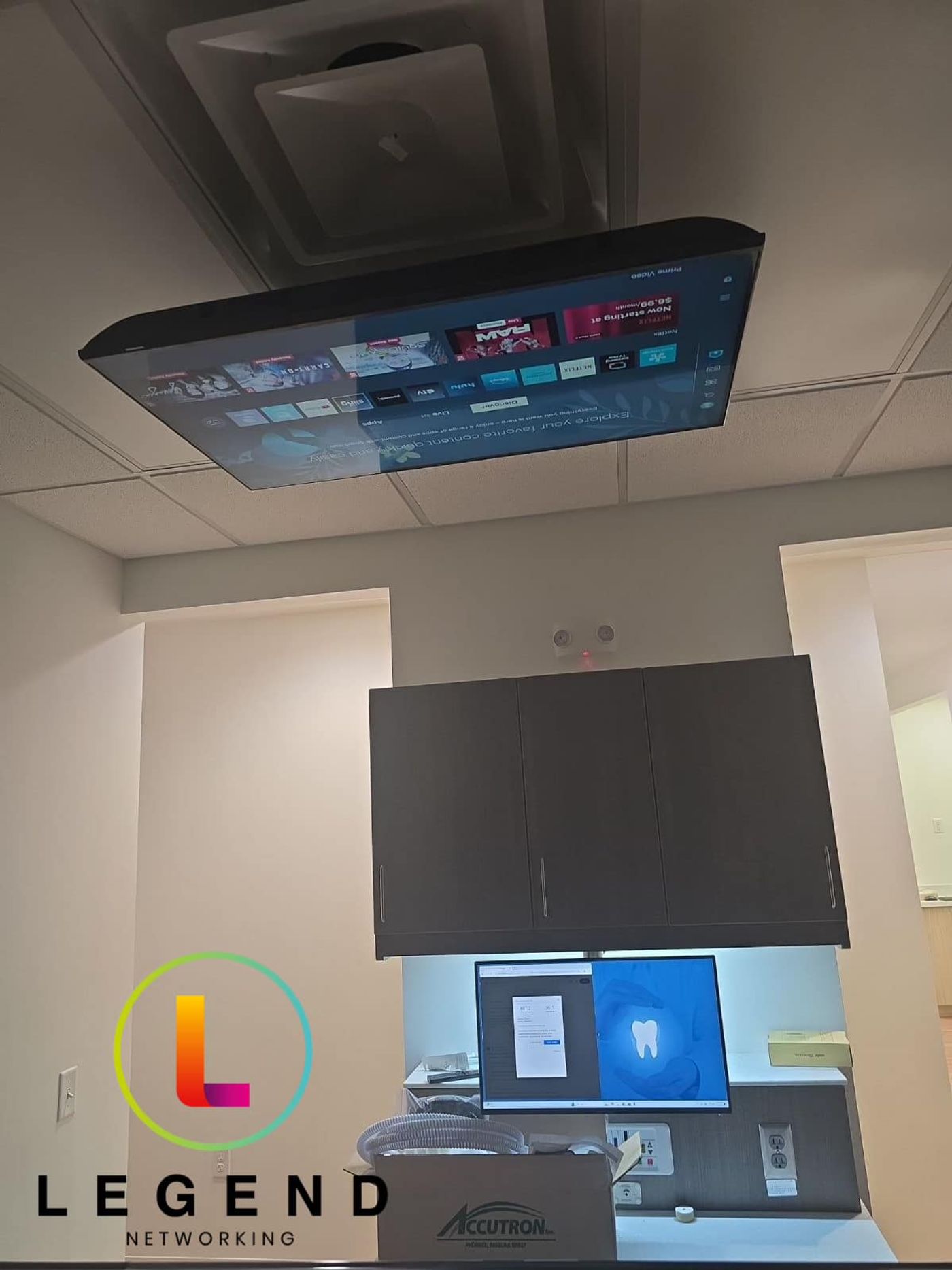 Treatment room with a ceiling-mounted TV and computer monitor at Rosebud Dental & Wellness in Gahanna, OH