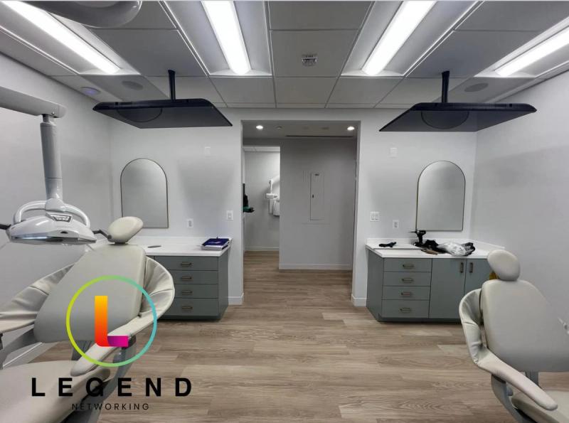 Open treatment bay with two dental chairs and ceiling-mounted monitors at Olney Pediatric Dentistry in Olney, MD