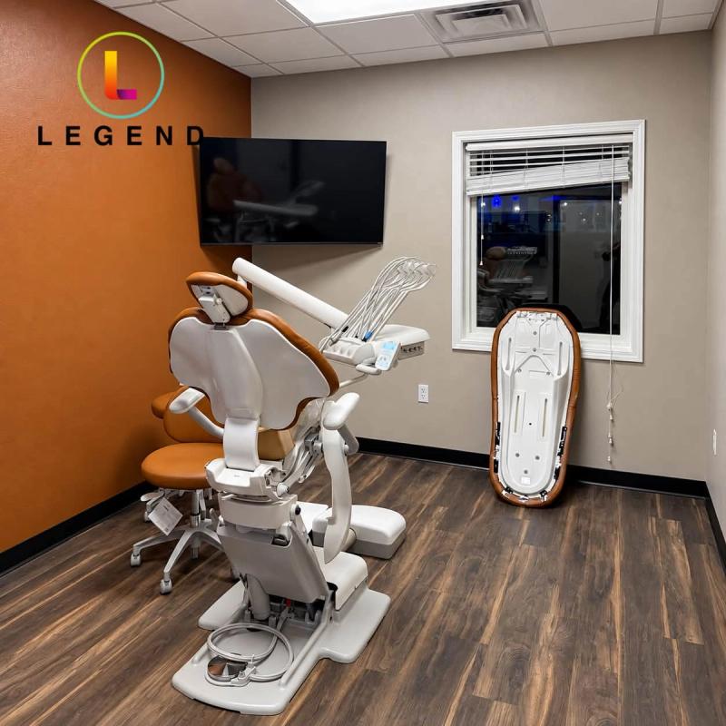 Treatment room with dental chair, wall-mounted TV and window at Rolla Periodontics & Implant Center, Rolla, MO