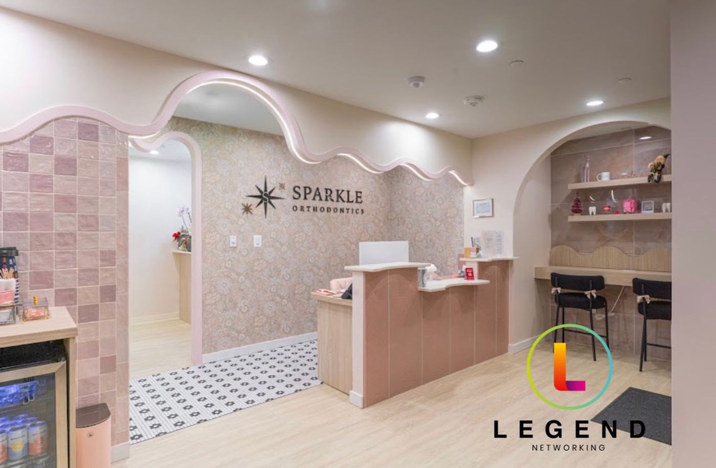 Reception desk beneath the Sparkle Orthodontics sign at the practice in Alexandria, VA