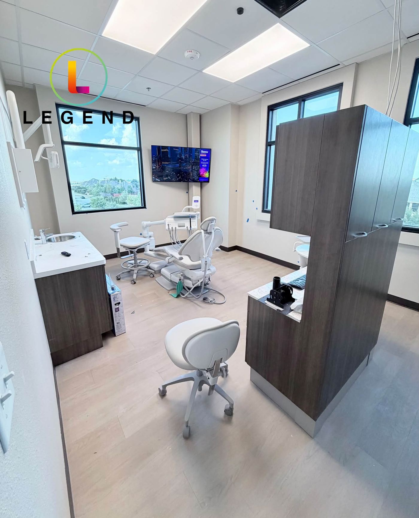 New operatory with dental chairs, cabinetry and a wall-mounted TV at Flourish Dental Boutique in Frisco, TX