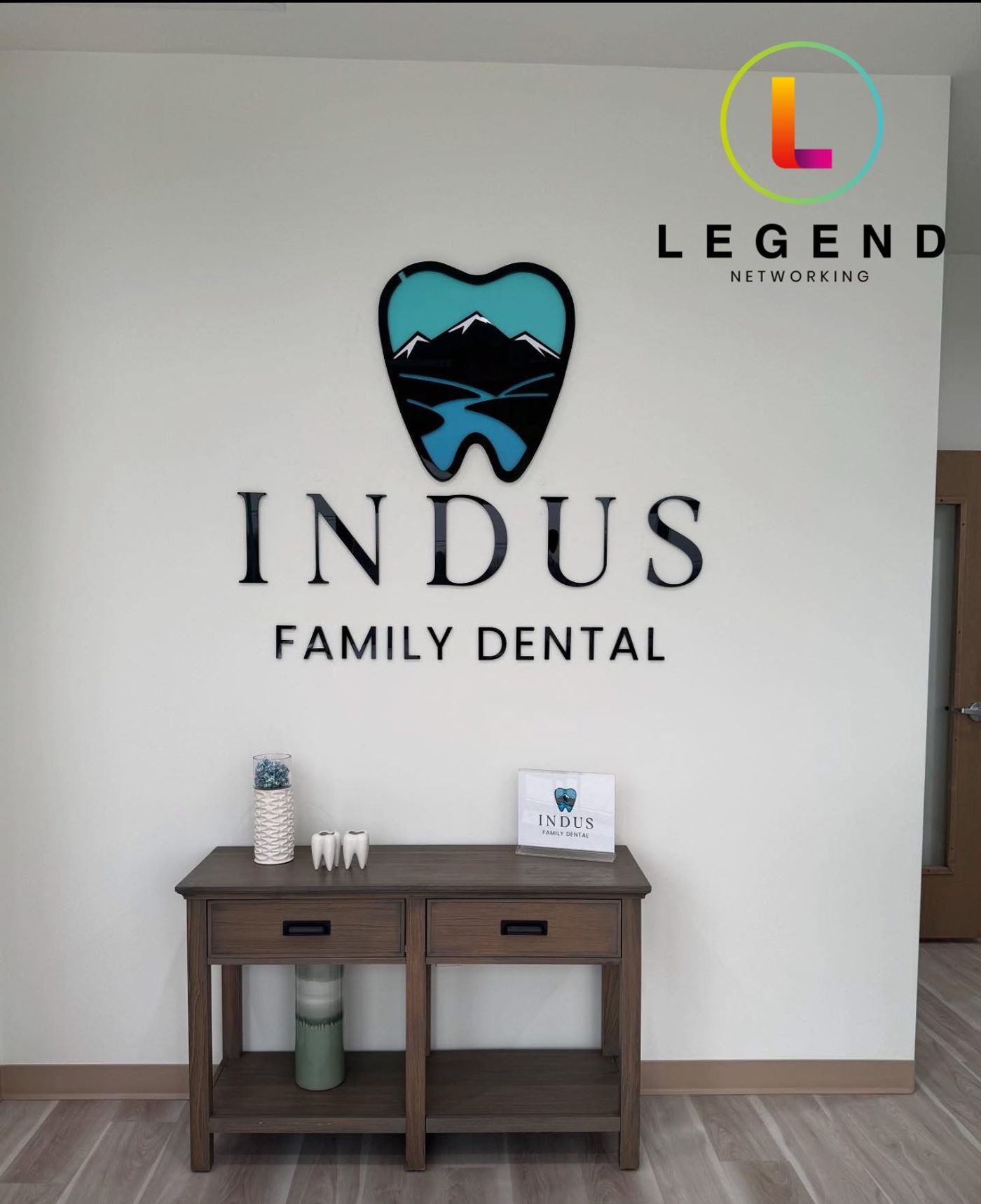 Indus Family Dental wall sign above a reception console in Wylie, TX