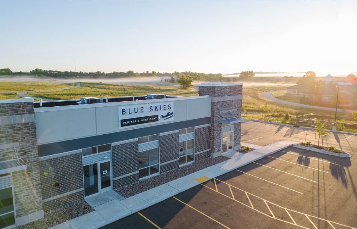 Exterior of Blue Skies Pediatric Dentistry with its sign on the building in Verona