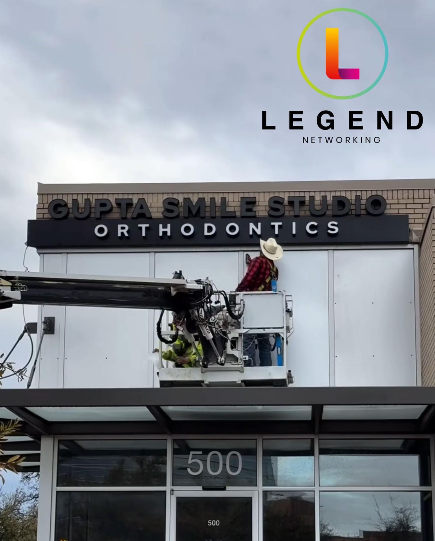 Gupta Smile Studio Orthodontics sign being installed above the entrance in Dallas, TX