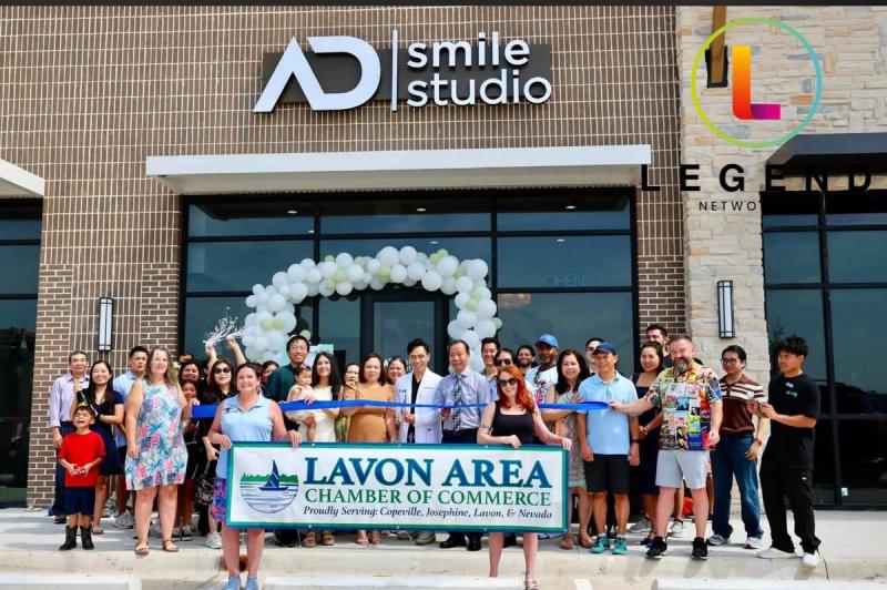 Ribbon-cutting crowd outside the entrance of AD Smile Studio in Lavon