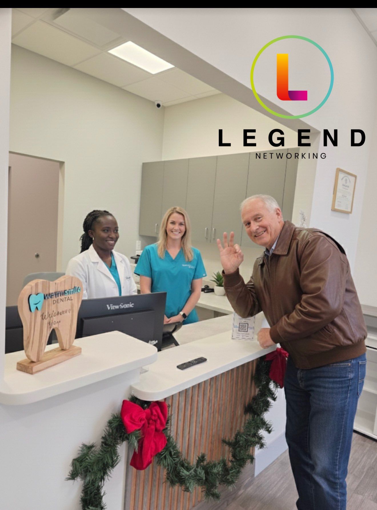 Reception desk with a tooth-shaped Warm Smile Dental sign in Raleigh