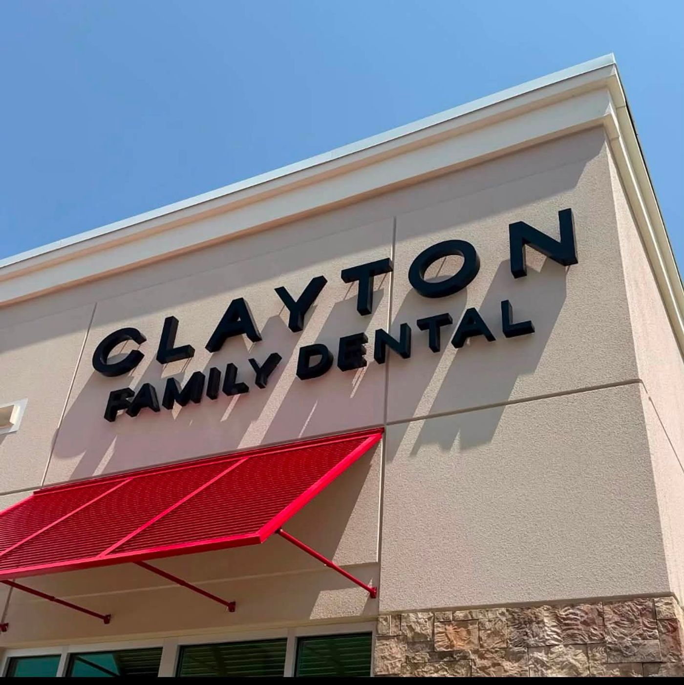 Clayton Family Dental exterior sign above a red awning in Clayton, NC