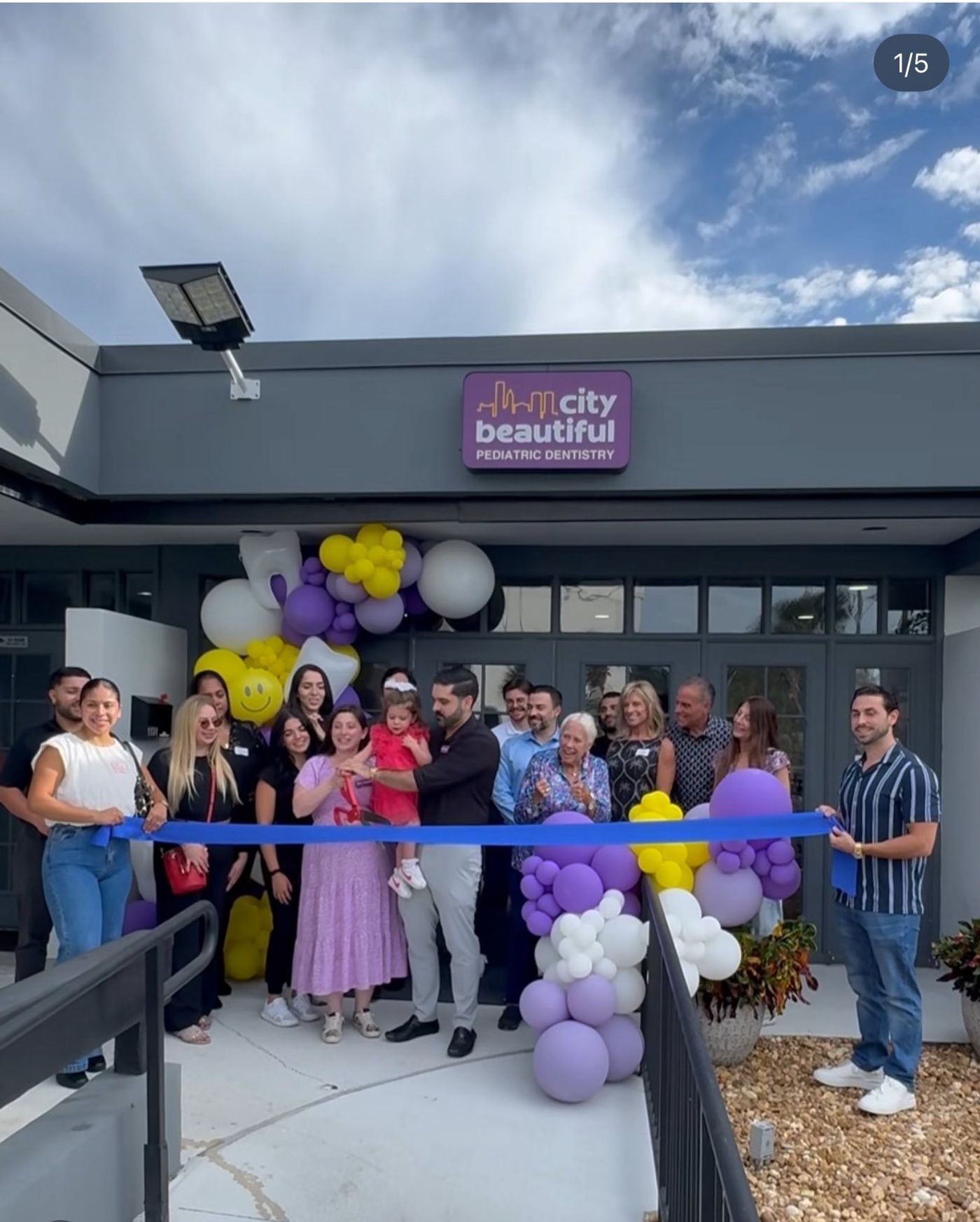 Ribbon cutting with balloons at the entrance of City Beautiful Pediatric Dentistry in Orlando, FL