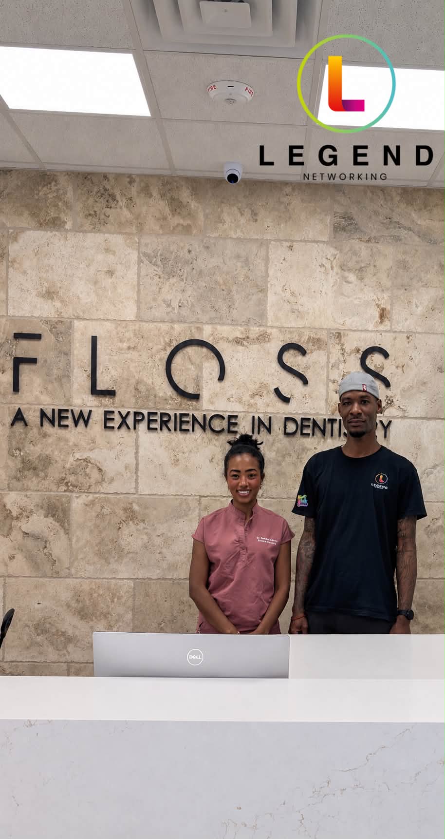 Reception desk with the FLOSS wall sign at Floss Dental in Roswell