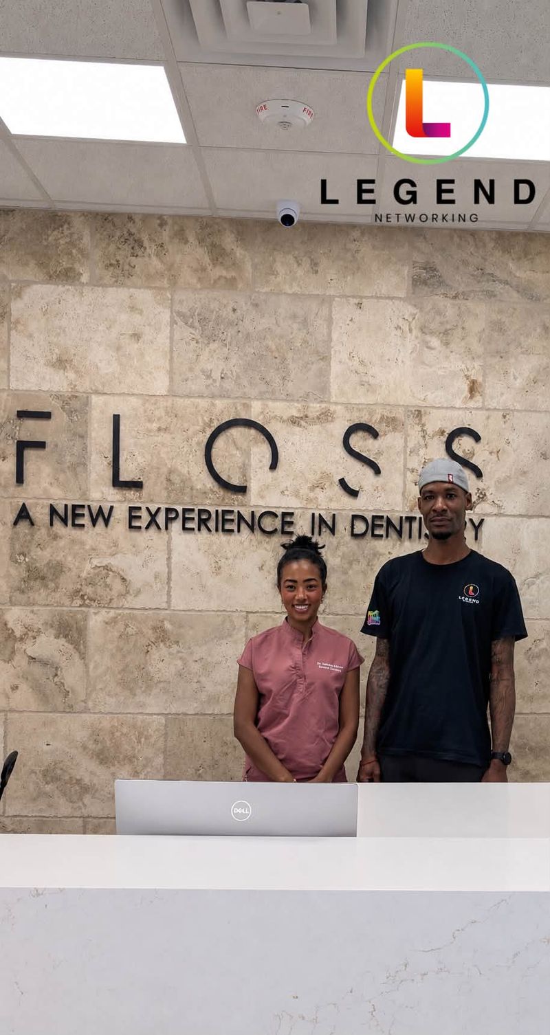 Reception desk with the FLOSS wall sign at Floss Dental in Roswell