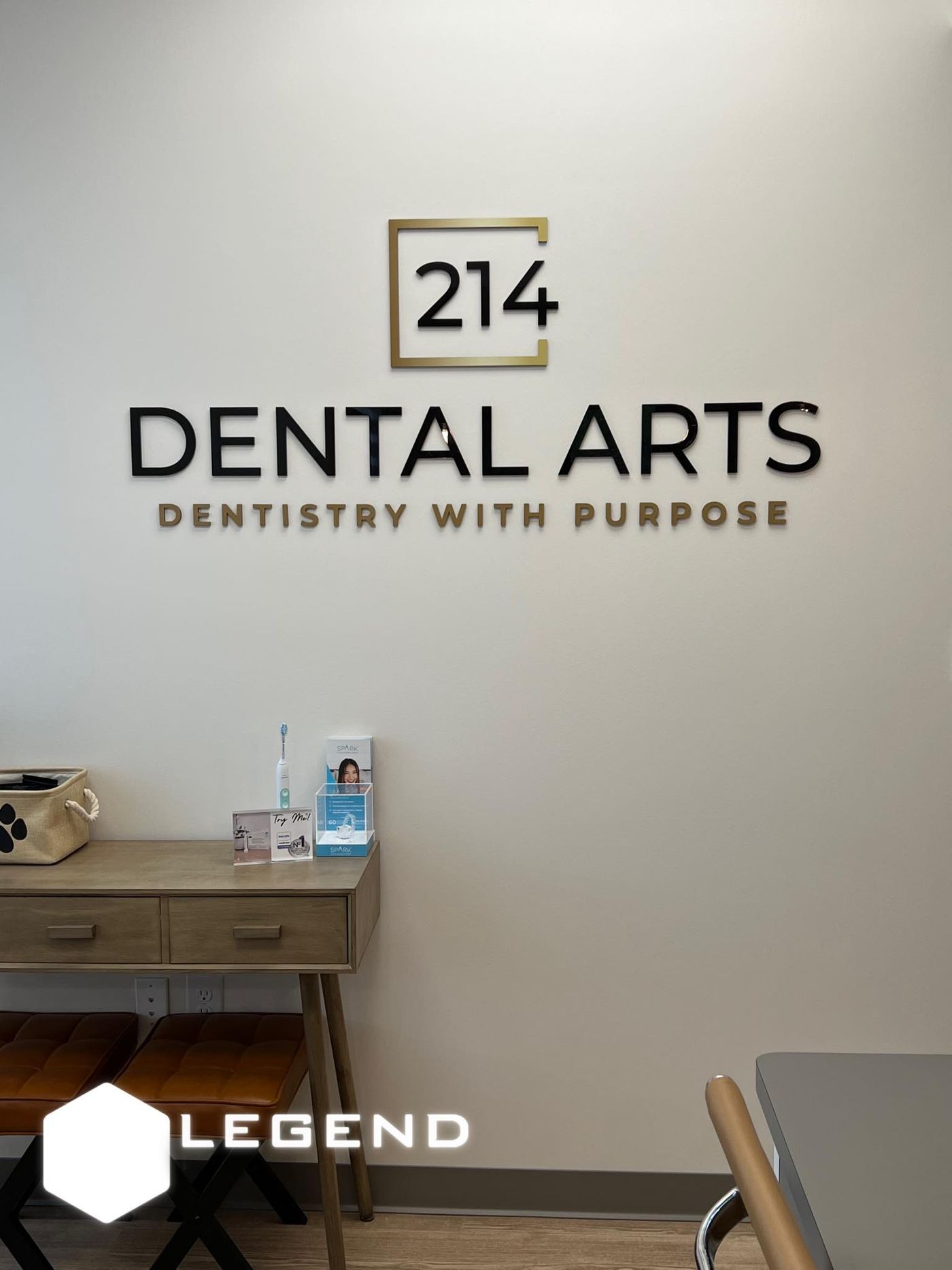 214 Dental Arts wall sign above a reception console in Flower Mound, TX