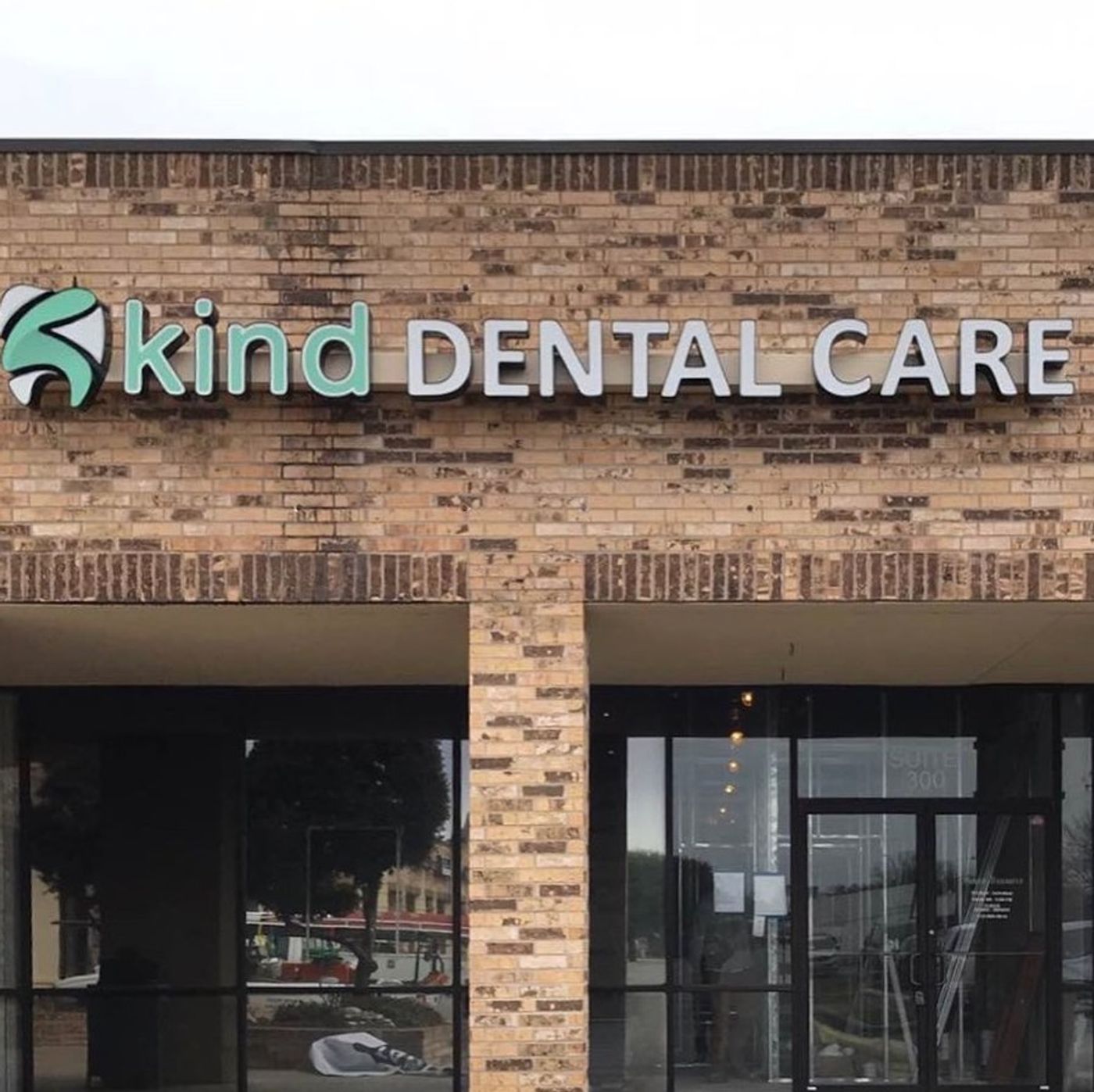 Kind Dental Care sign on a brick storefront in Austin, TX