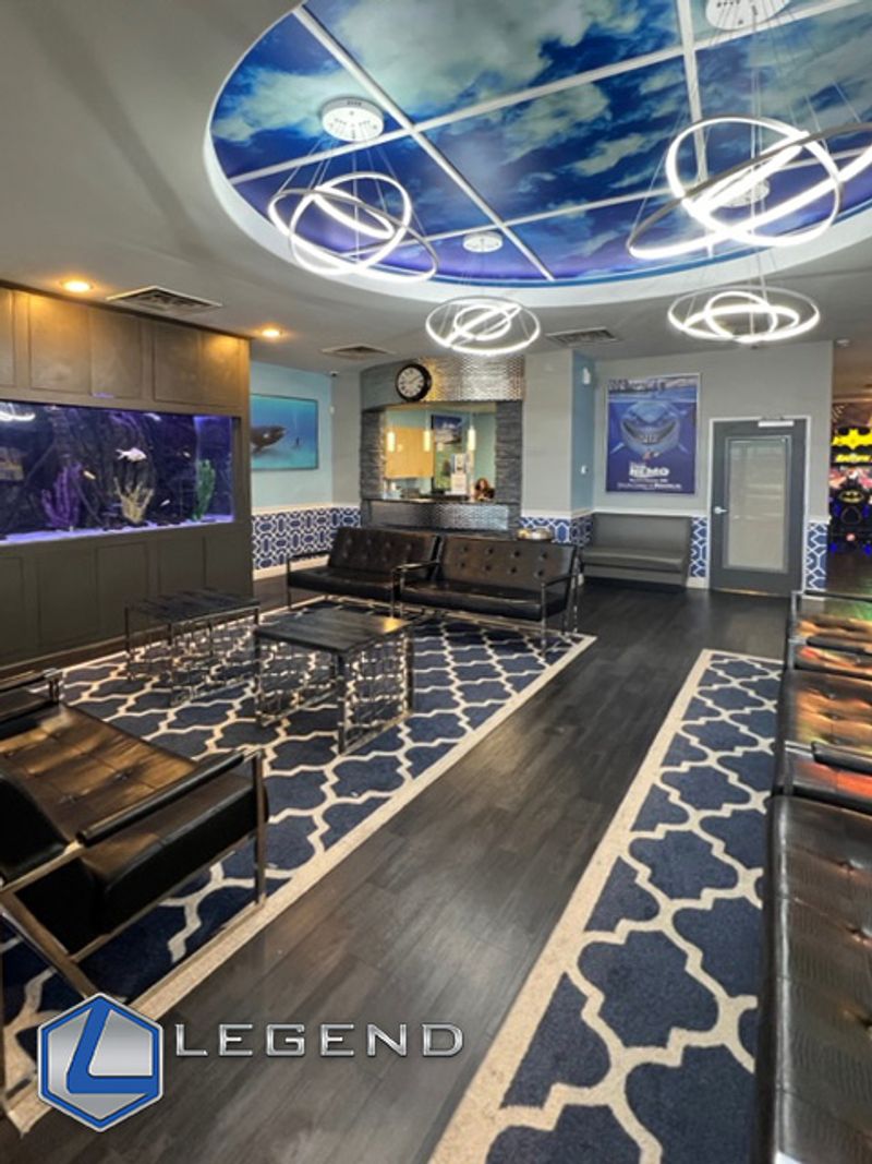 Waiting area with an aquarium and patterned rugs at Aqua Dental in Duncanville