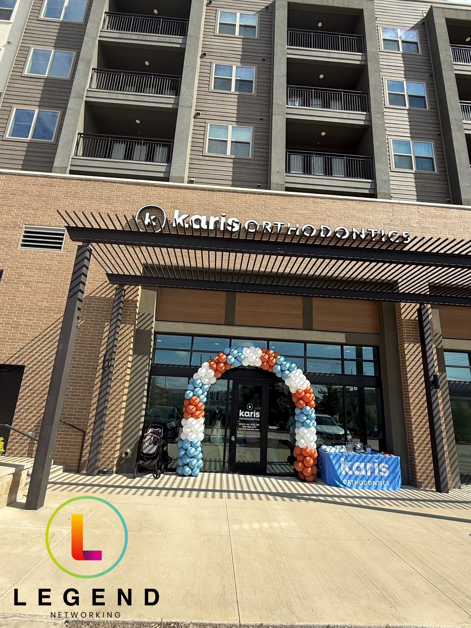 Storefront with signage and a balloon arch at Karis Orthodontics in Lewisville