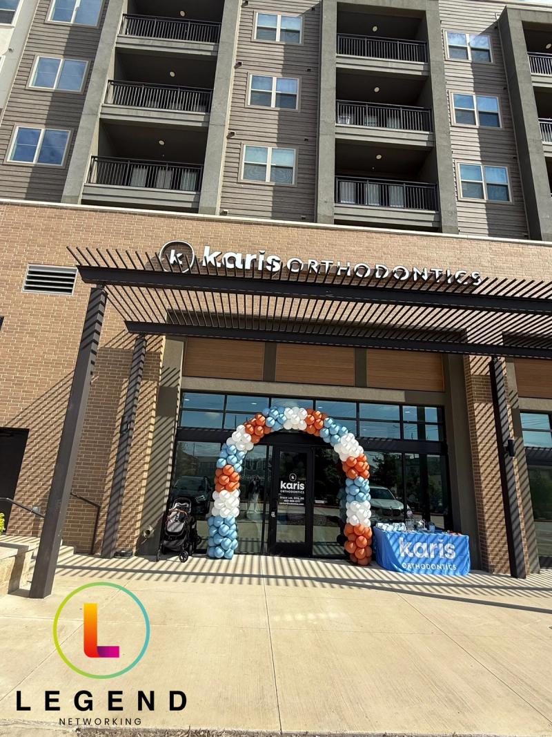 Storefront with signage and a balloon arch at Karis Orthodontics in Lewisville