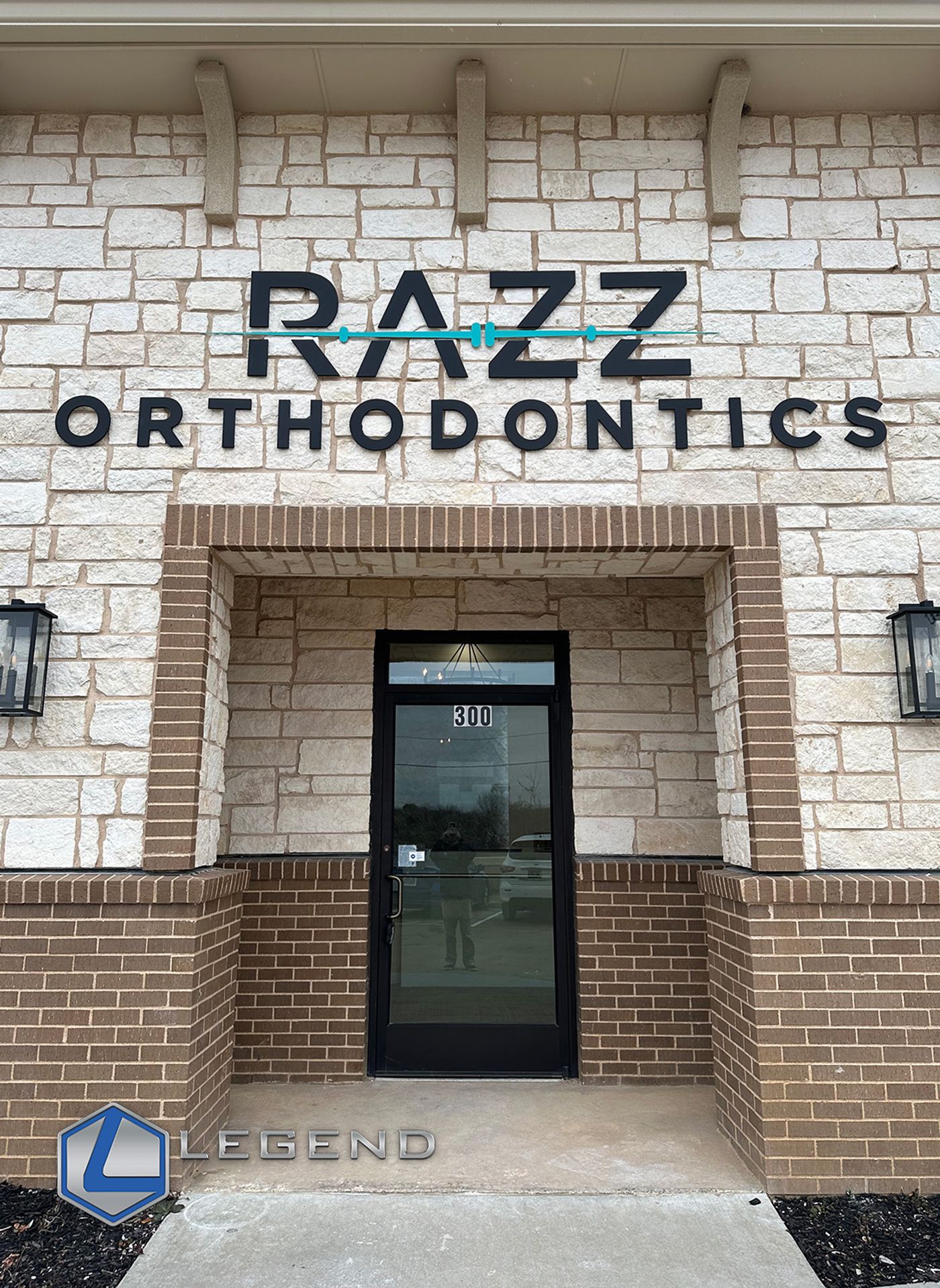 Razz Orthodontics sign above the stone entrance of the practice, Flower Mound, TX