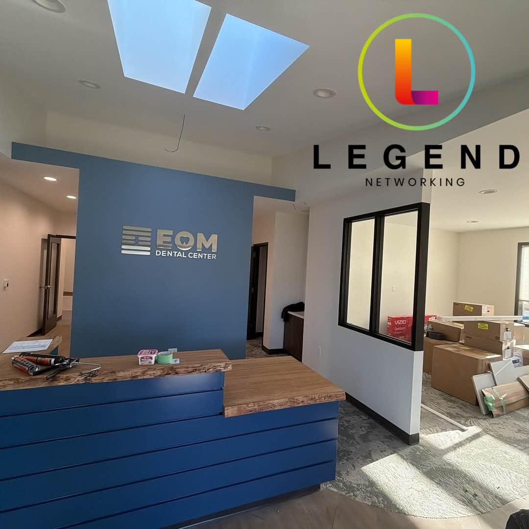 Reception desk and EOM Dental Center sign wall during final buildout at EOM Dental Center in Sequim