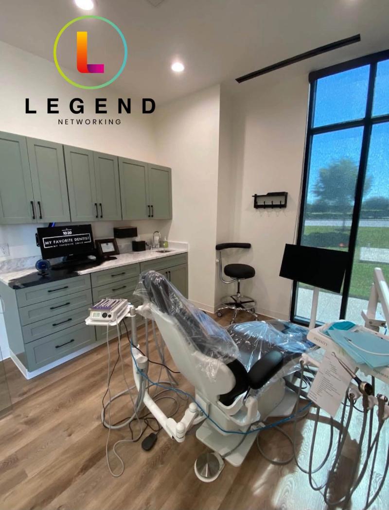Dental operatory with patient chair, cabinetry and wall-mounted monitor at My Favorite Dentist in Georgetown, TX
