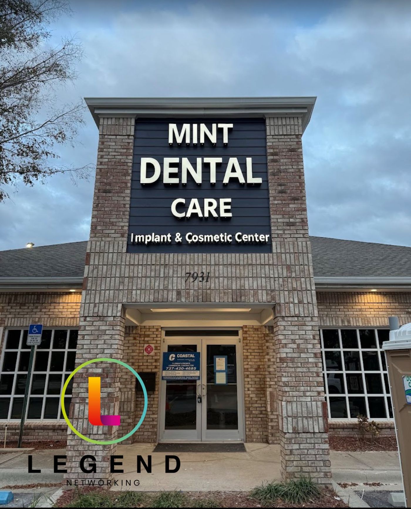 Brick entrance and Mint Dental Care Implant & Cosmetic Center sign at the practice in Tampa, FL