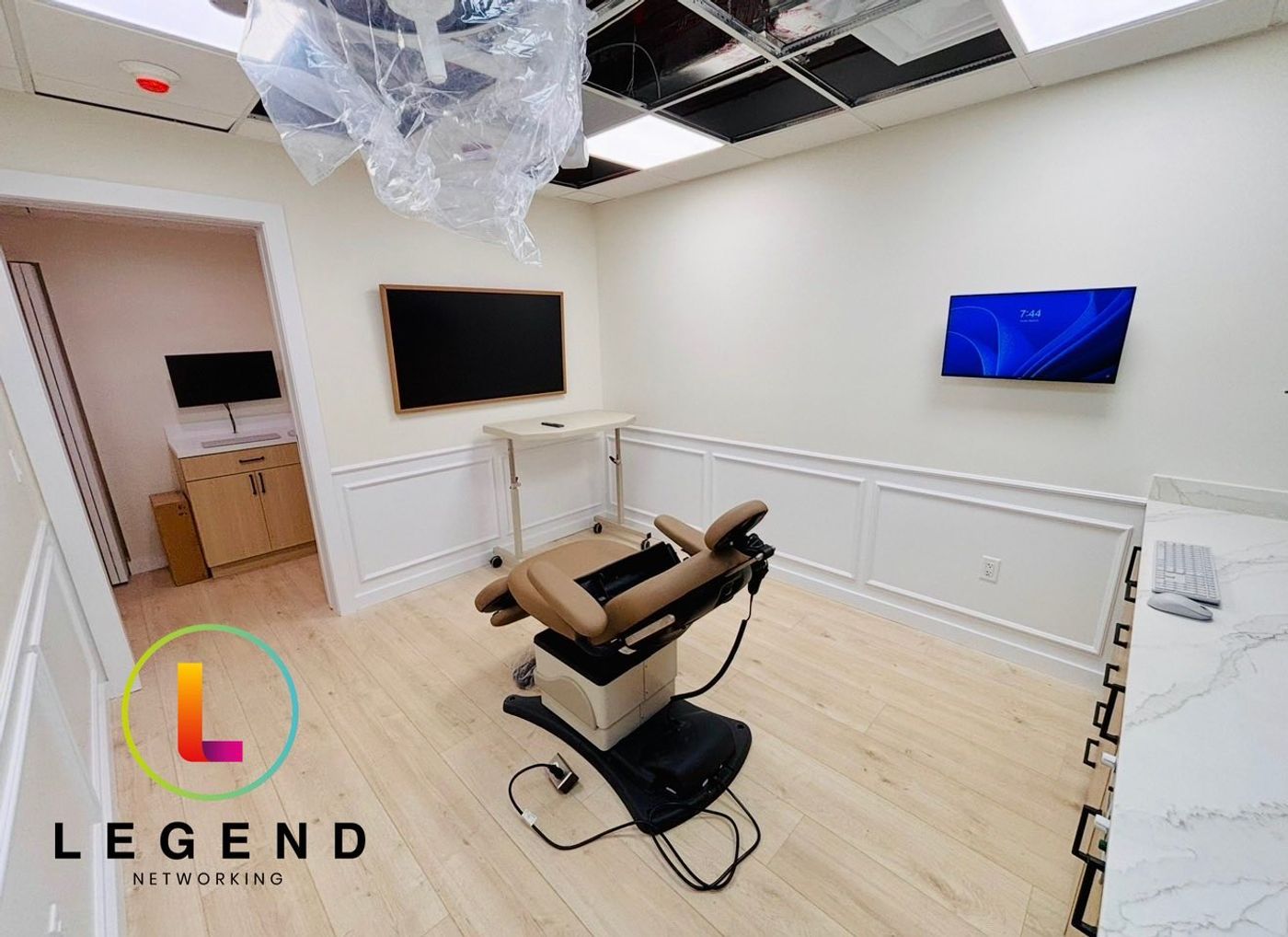 Surgical suite with patient chair and wall-mounted displays at Ecker Oral Surgery in Miami, FL