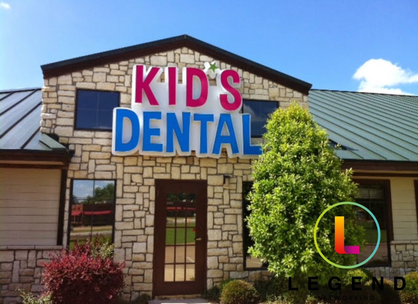 Stone building with a Kid's Dental sign over the entrance of Wylie Children's Dentistry, Wylie, TX
