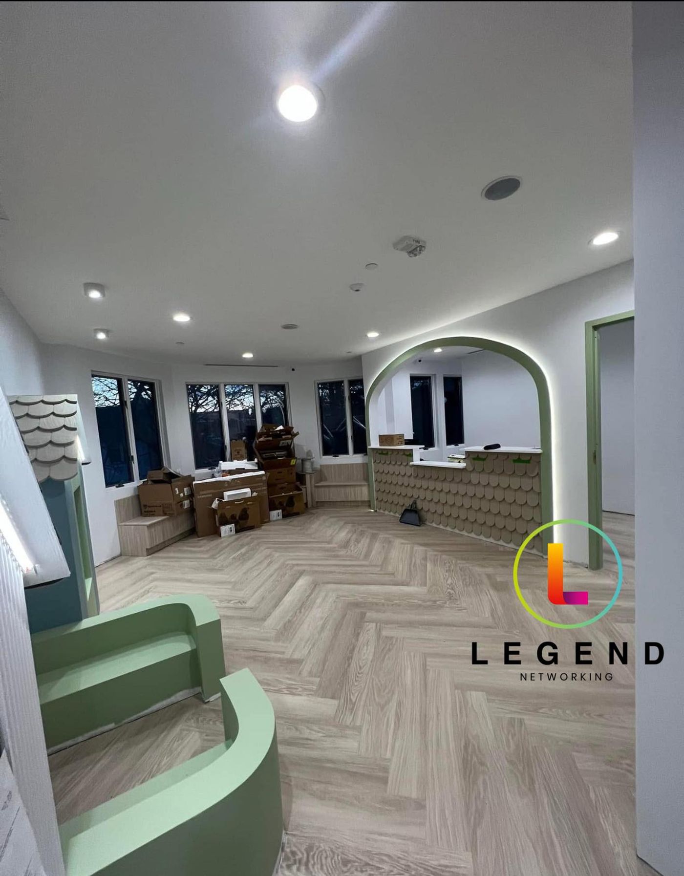 Reception and lobby with green curved bench and arched doorway at Olney Pediatric Dentistry in Olney, MD