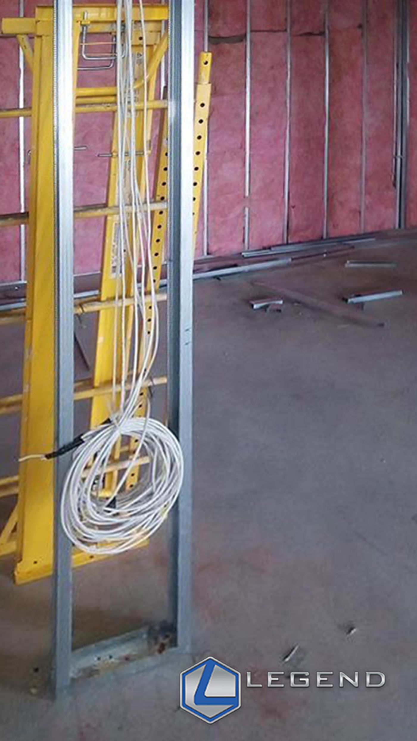 Coiled network cable at a steel-framed wall during buildout at Plaque Panther Dentistry, Hutto, TX