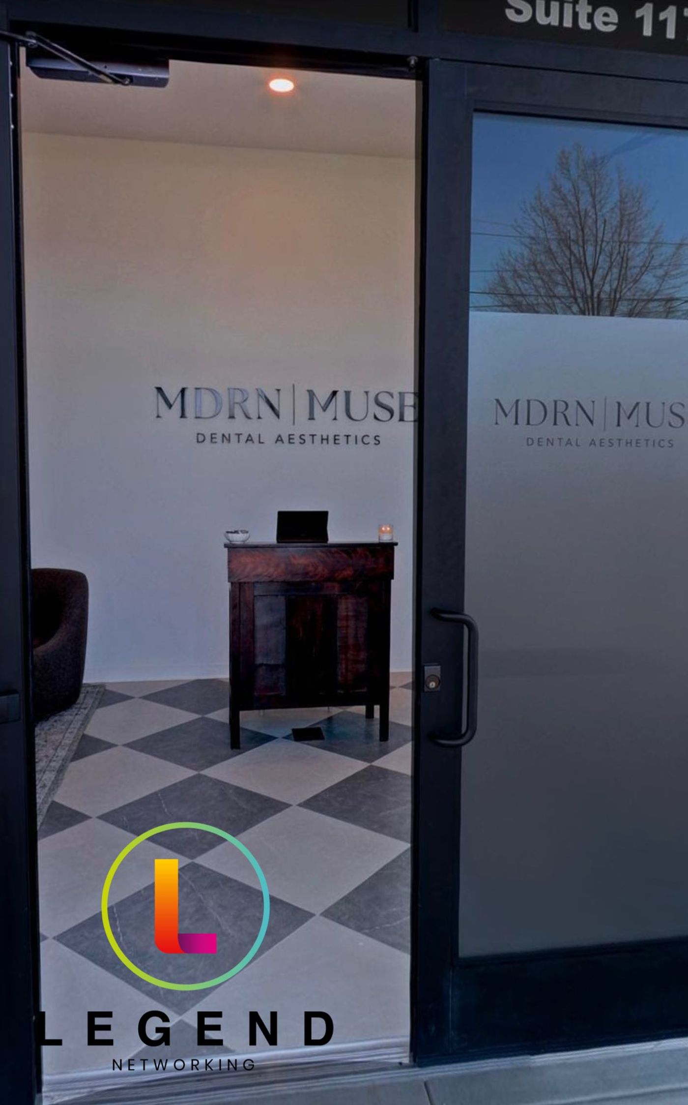 Glass entrance door with practice name decal at MDRN MUSE Dental Aesthetics, Chattanooga, TN