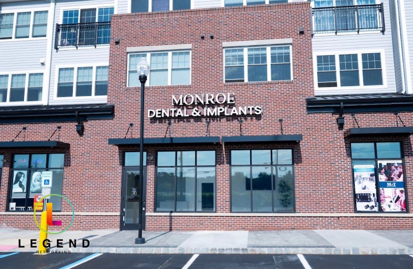 Storefront with Monroe Dental & Implants sign in Monroe Township, NJ