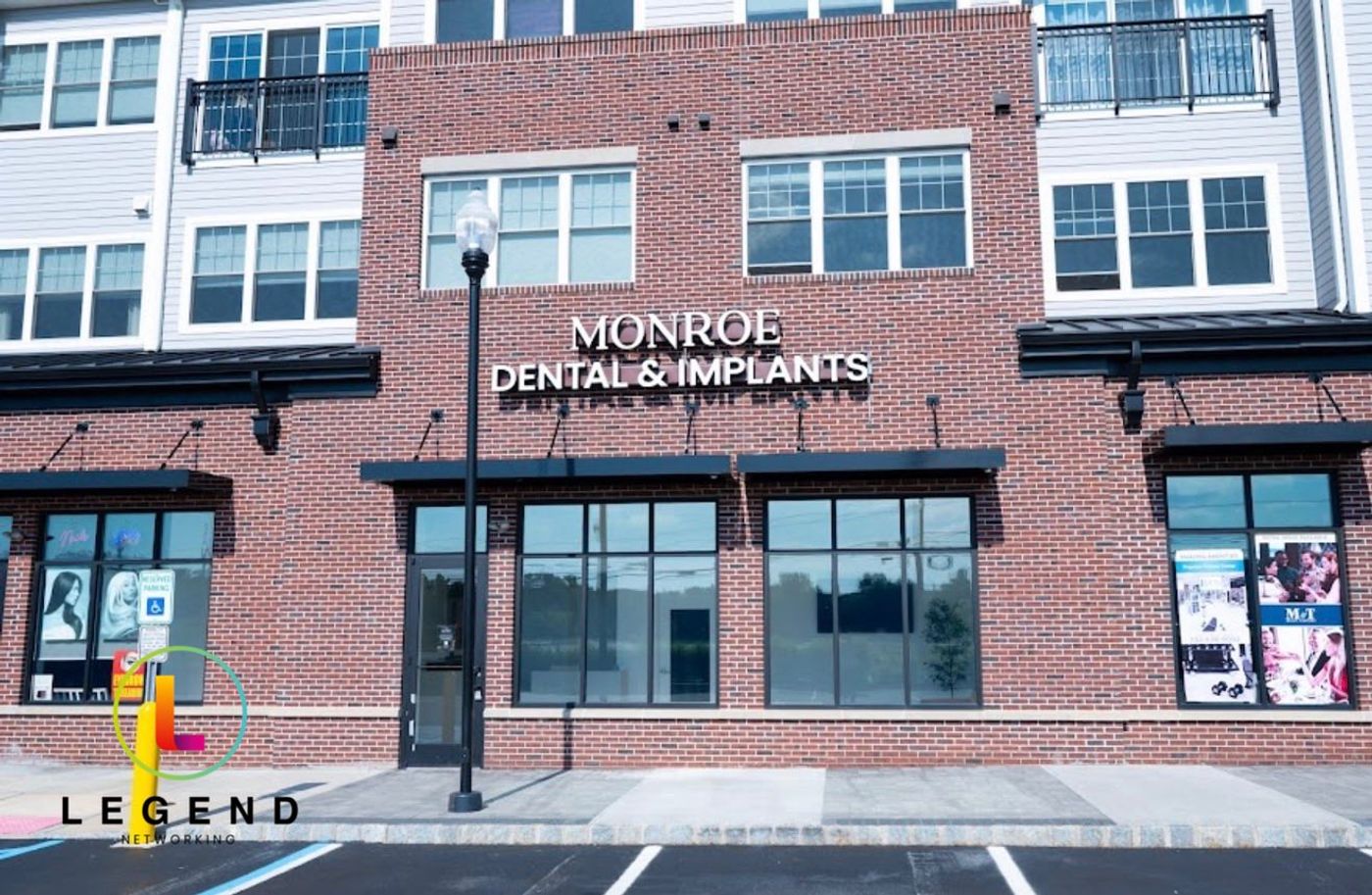 Storefront with Monroe Dental & Implants sign on a brick building in Monroe Township, NJ