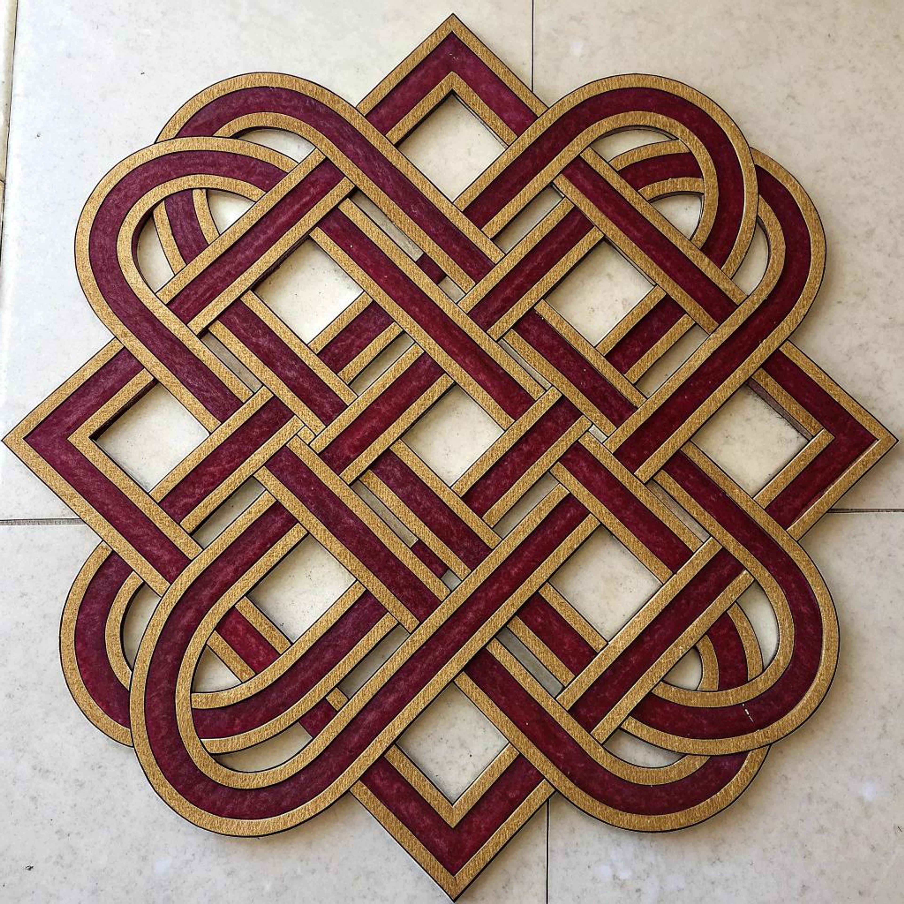 Gouden vlechtwerk op tegels
