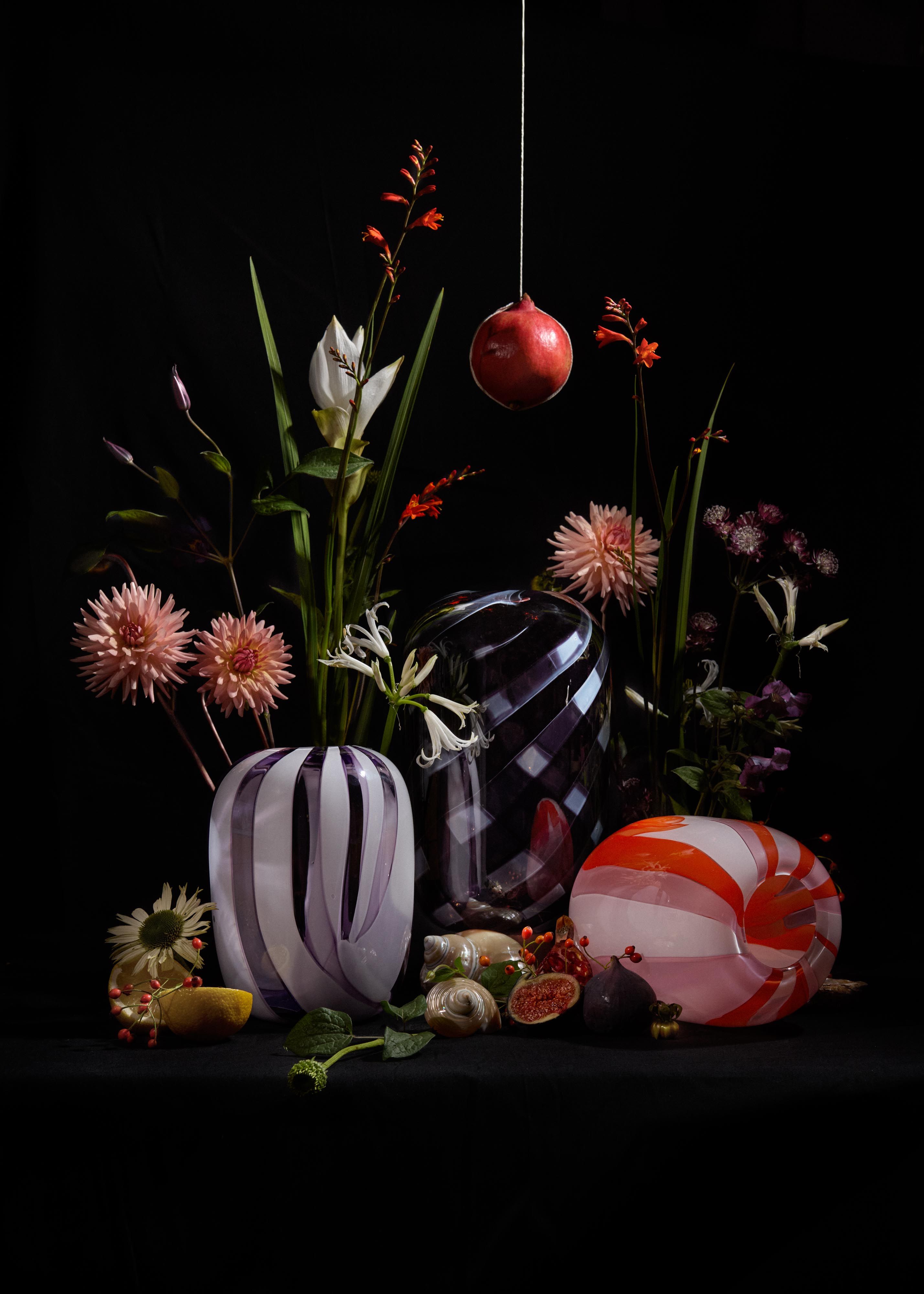 colorful vases and flowers on a black background