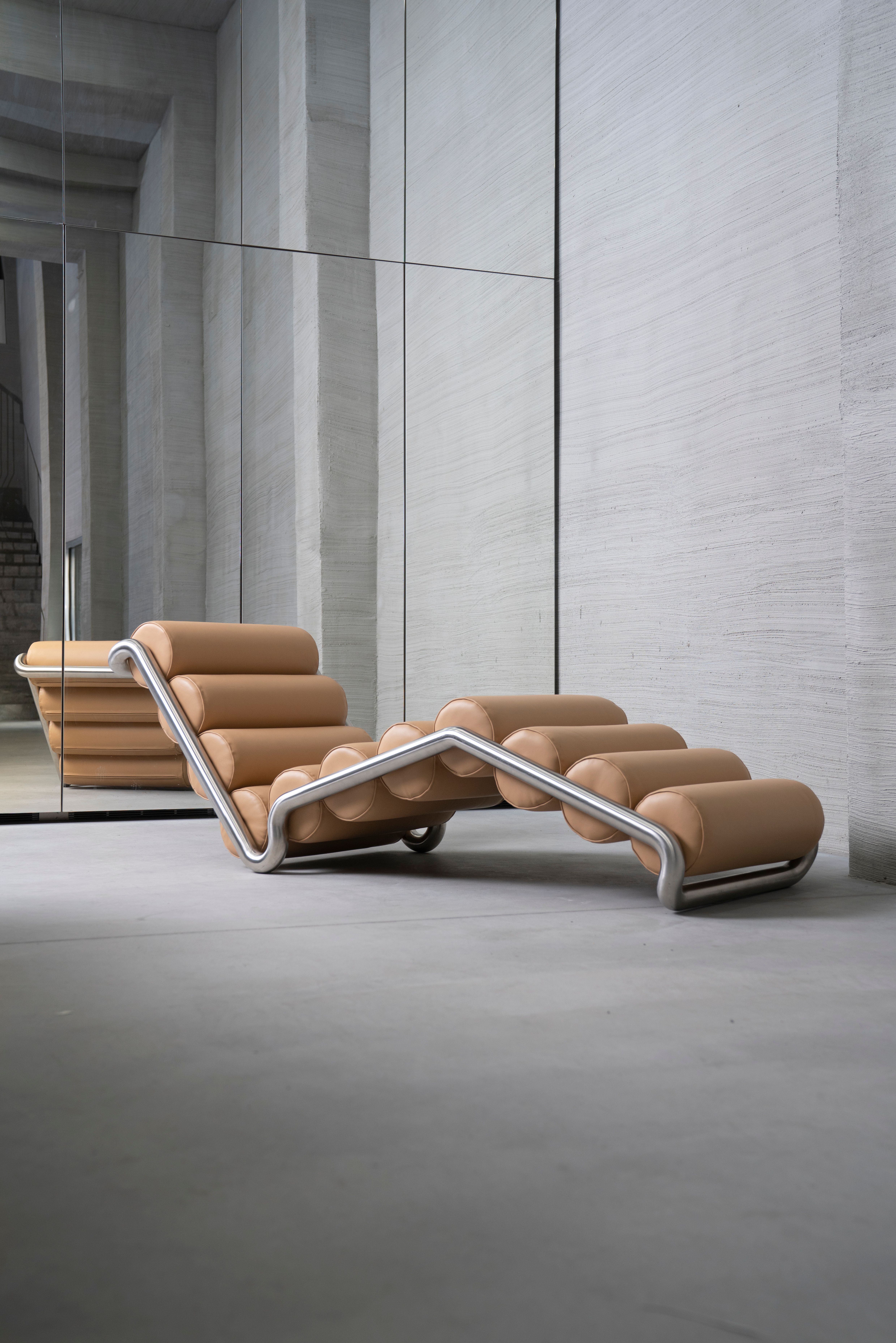 brown and metall Chaiselongue in front of a mirror