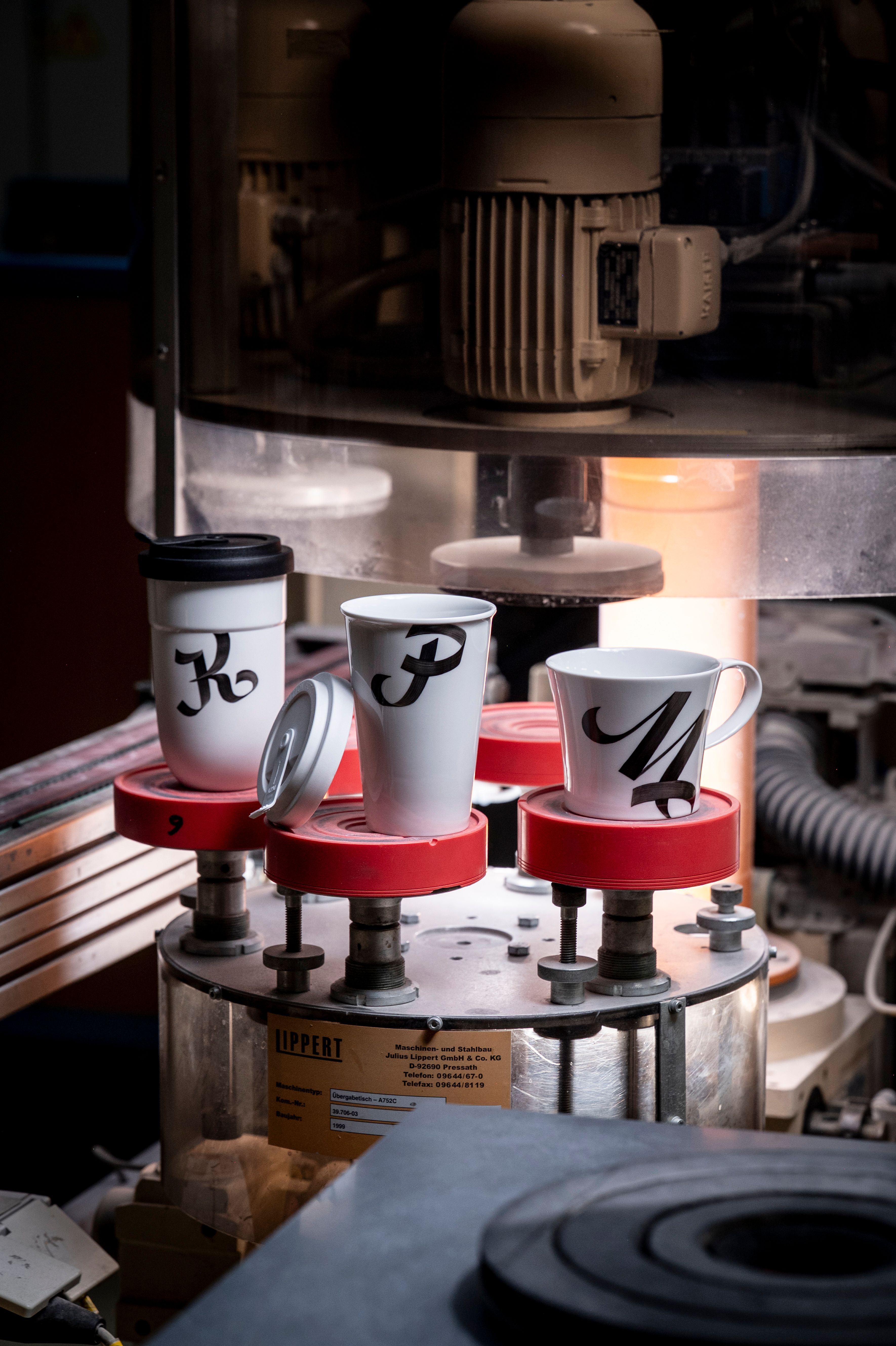 a view of the workshop of KPM Berlin in Berlin, three cups handpainted with letters