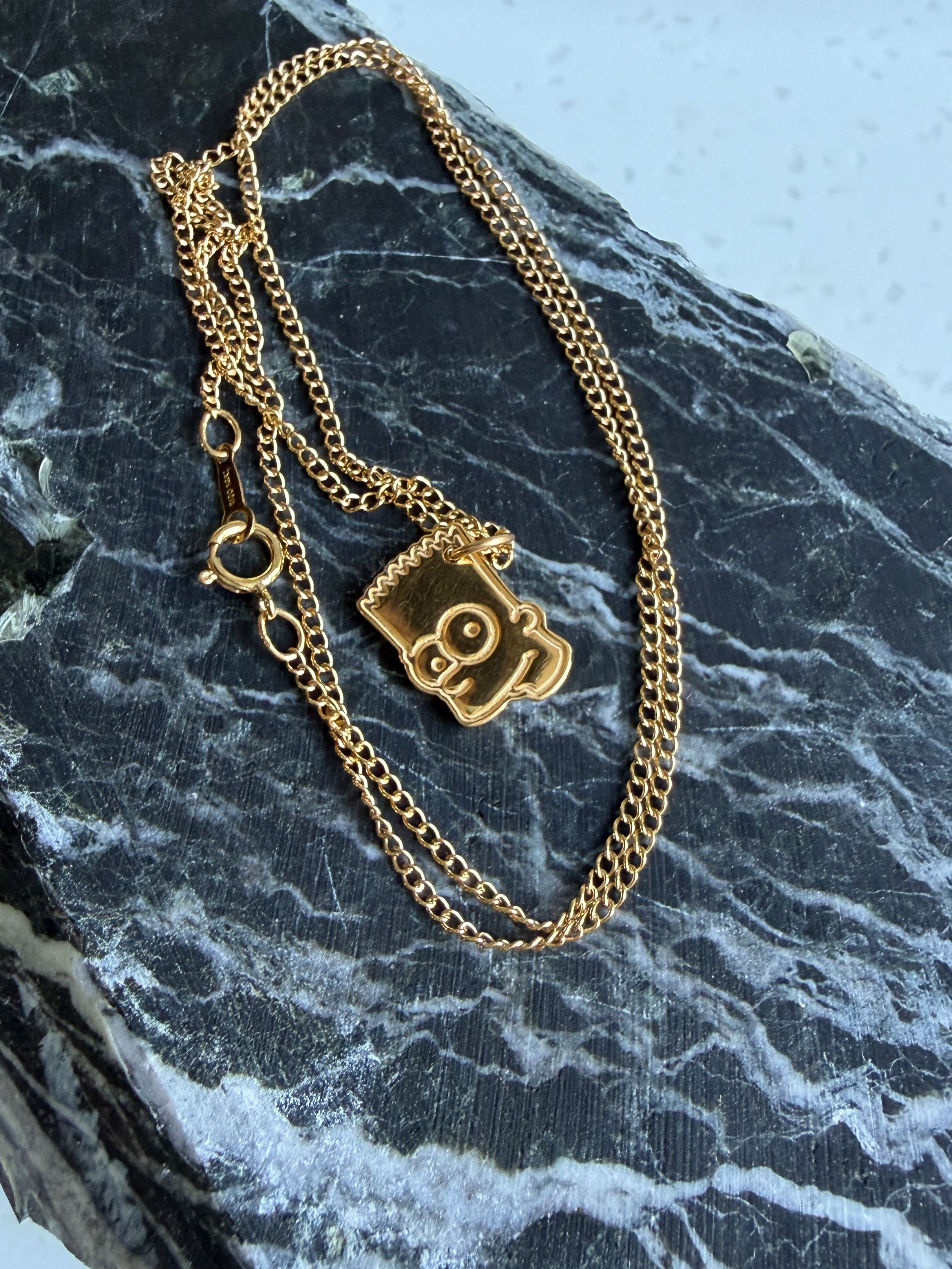 A golden bart head pendant