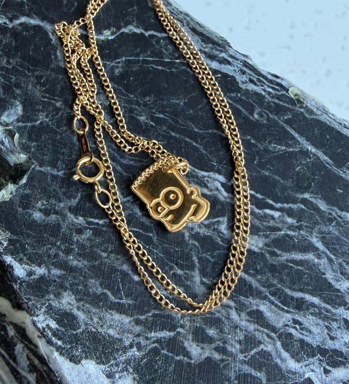 A golden bart head pendant