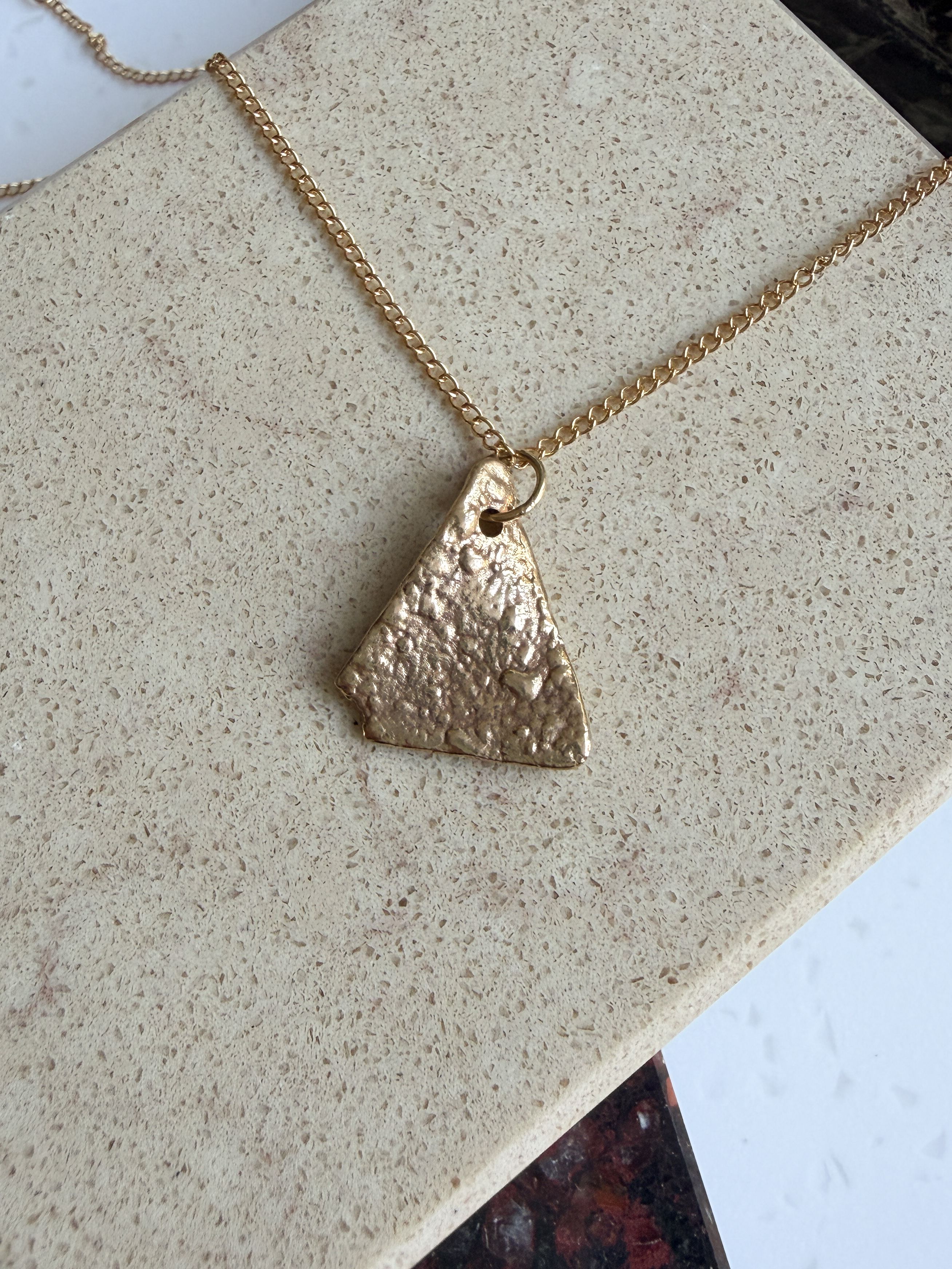 A small golden dorito pendant