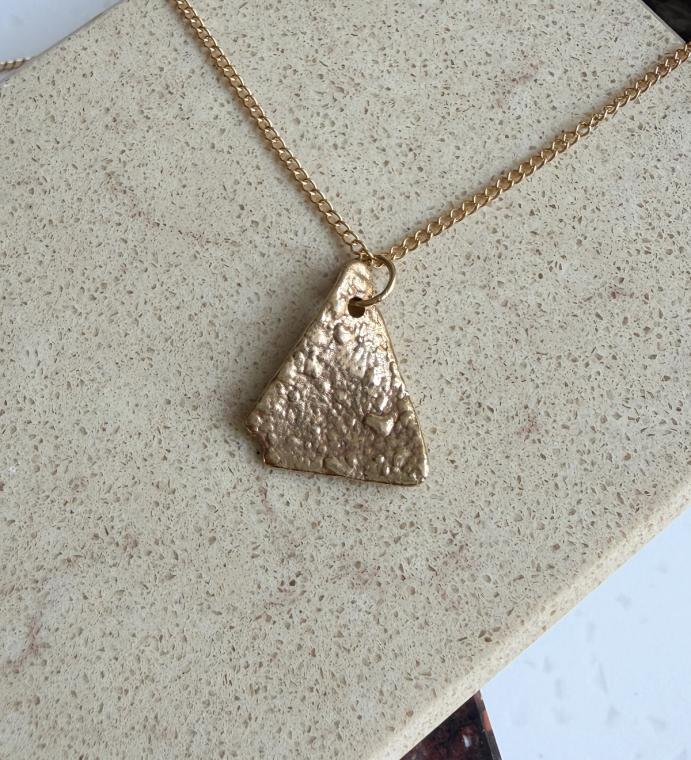 A small golden dorito pendant