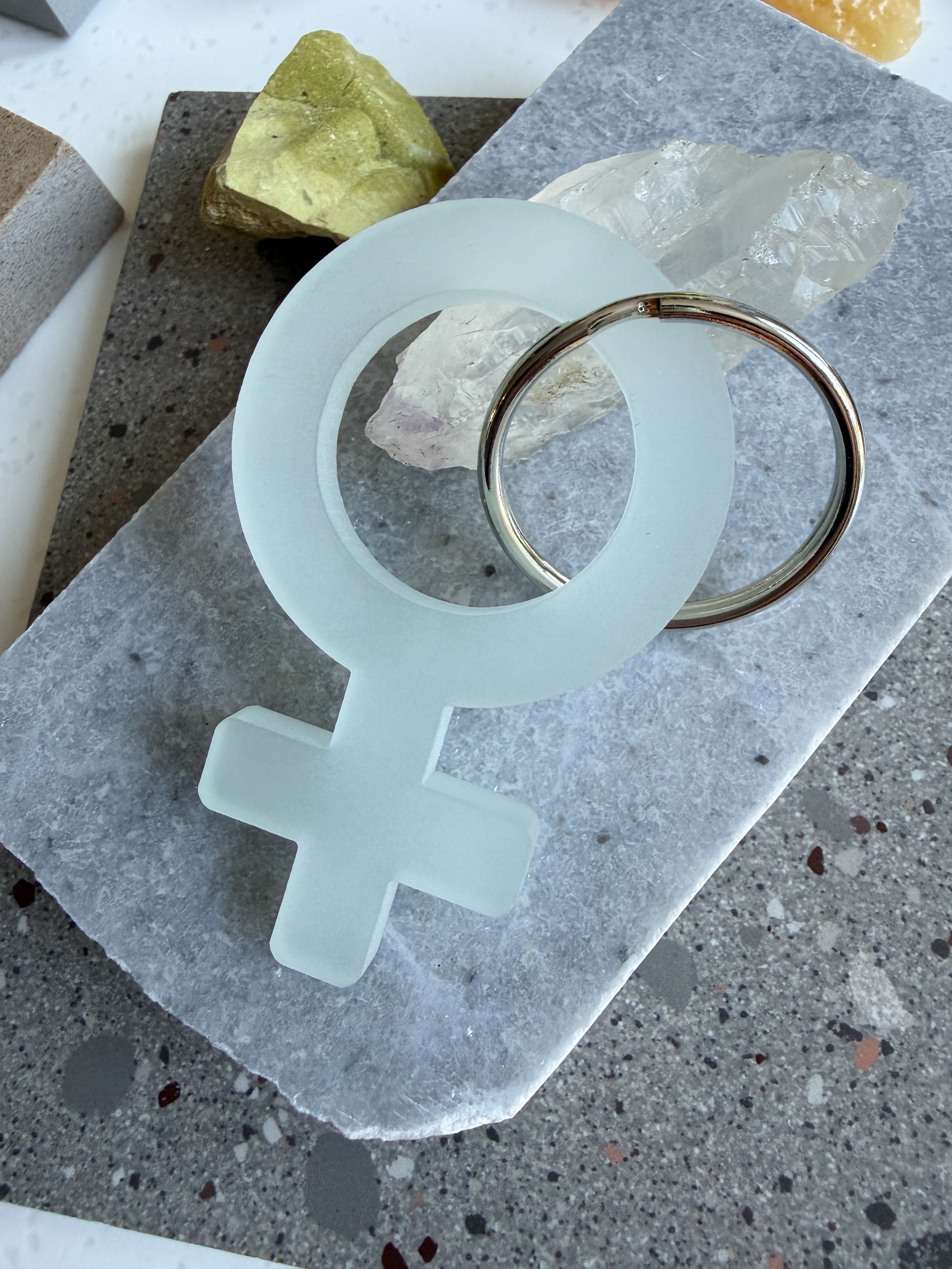 A frosted mint woman symbol keychain