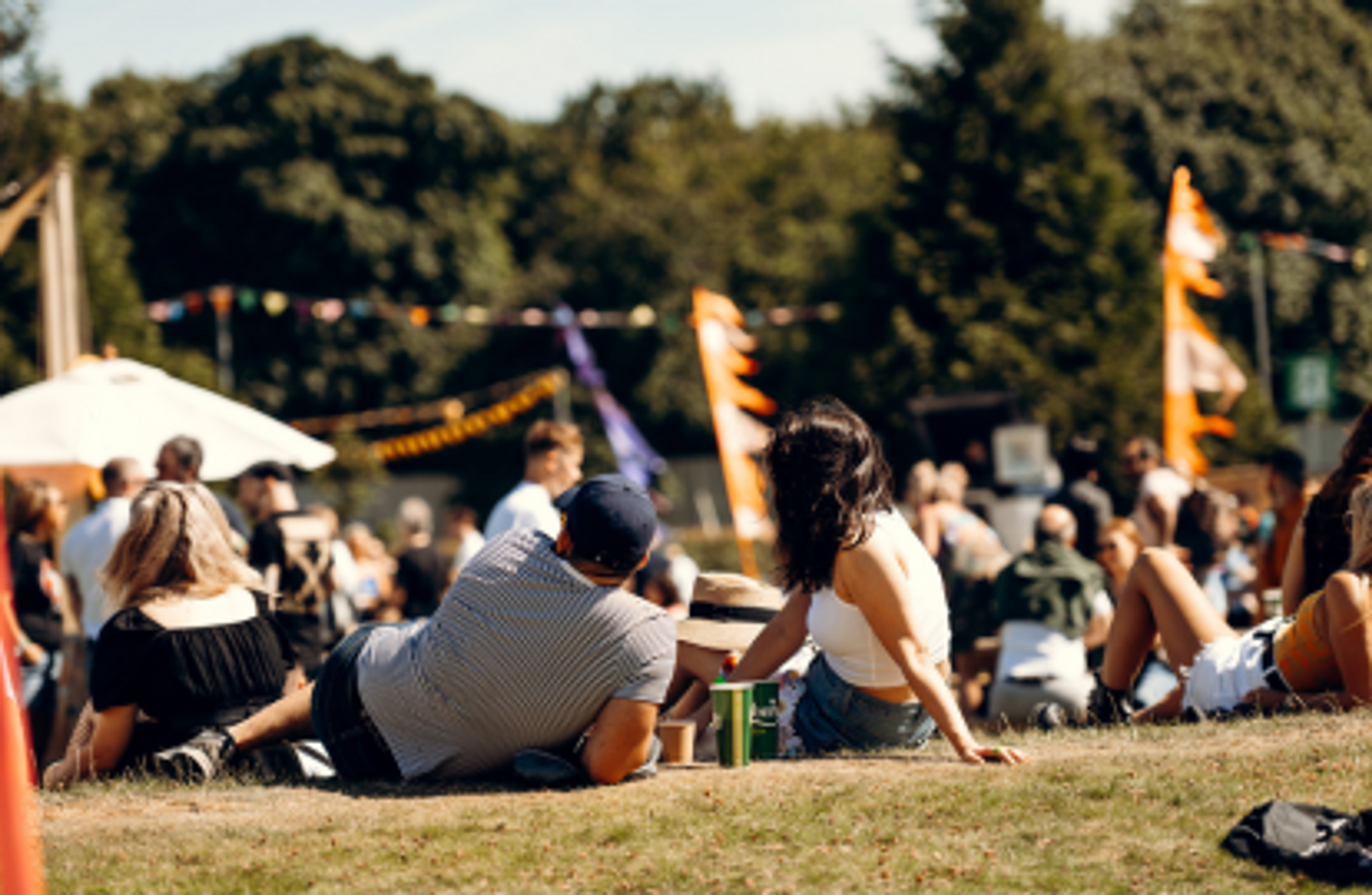 People relaxing on the grass at a festival