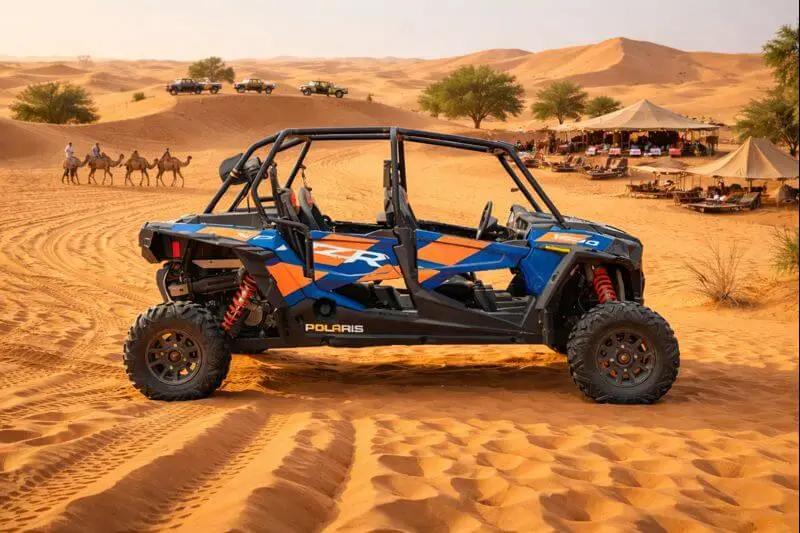 Passengers wearing goggles and scarves in a desert buggy
