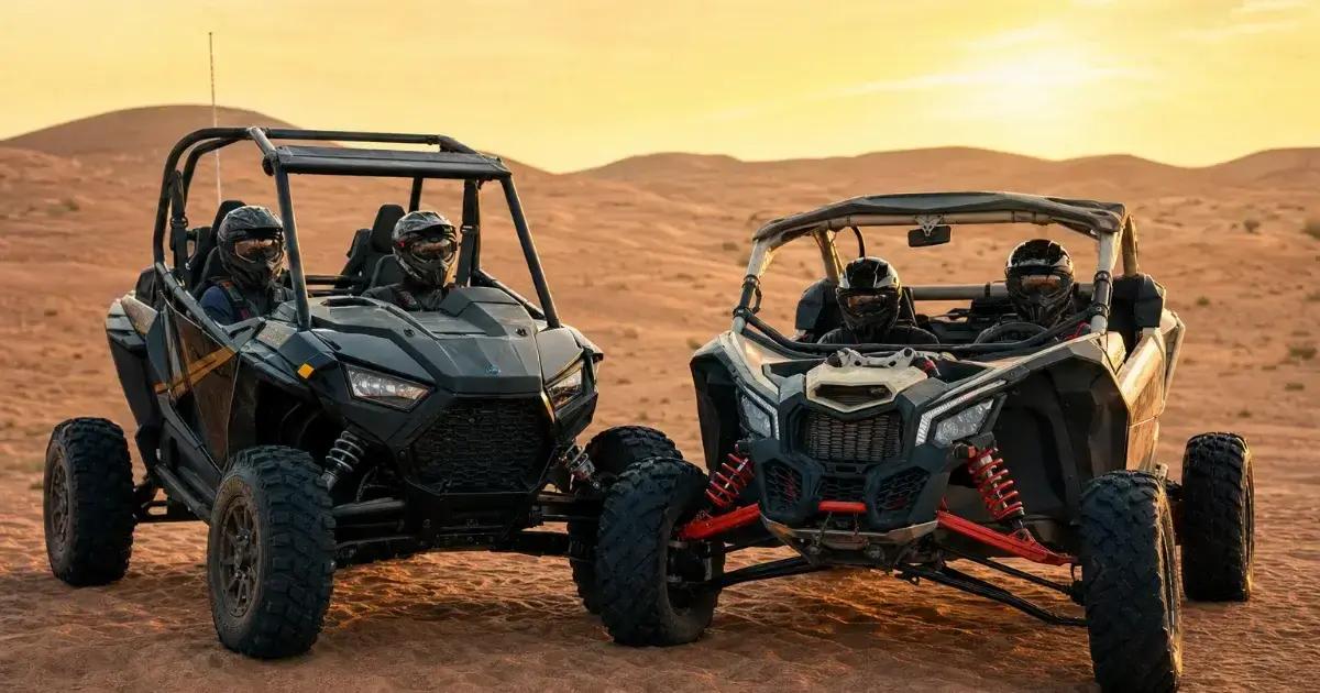Buggy climbing a tall sand dune in the afternoon light