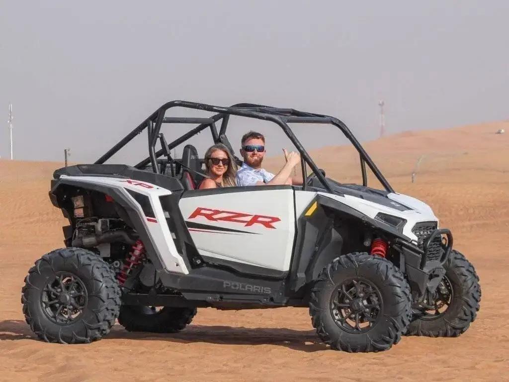 Buggy driving over sand dunes on a Dubai desert tour